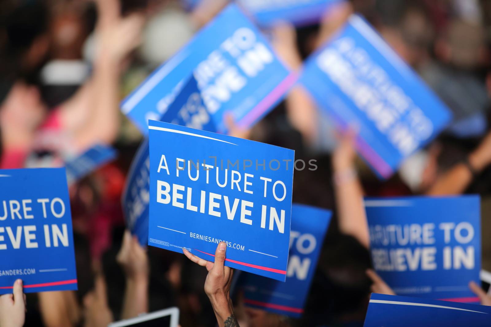 UNITED STATES, Phoenix: Members of the crowd show their support for Democratic presidential candidate Sen. Bernie Sanders at the Phoenix Convention Center during a campaign rally on March 15, 2016 in Phoenix, Arizona. Hillary Clinton won the Democratic primary elections in Florida, North Carolina and Ohio, while Missouri and Illinois remain tight races.
