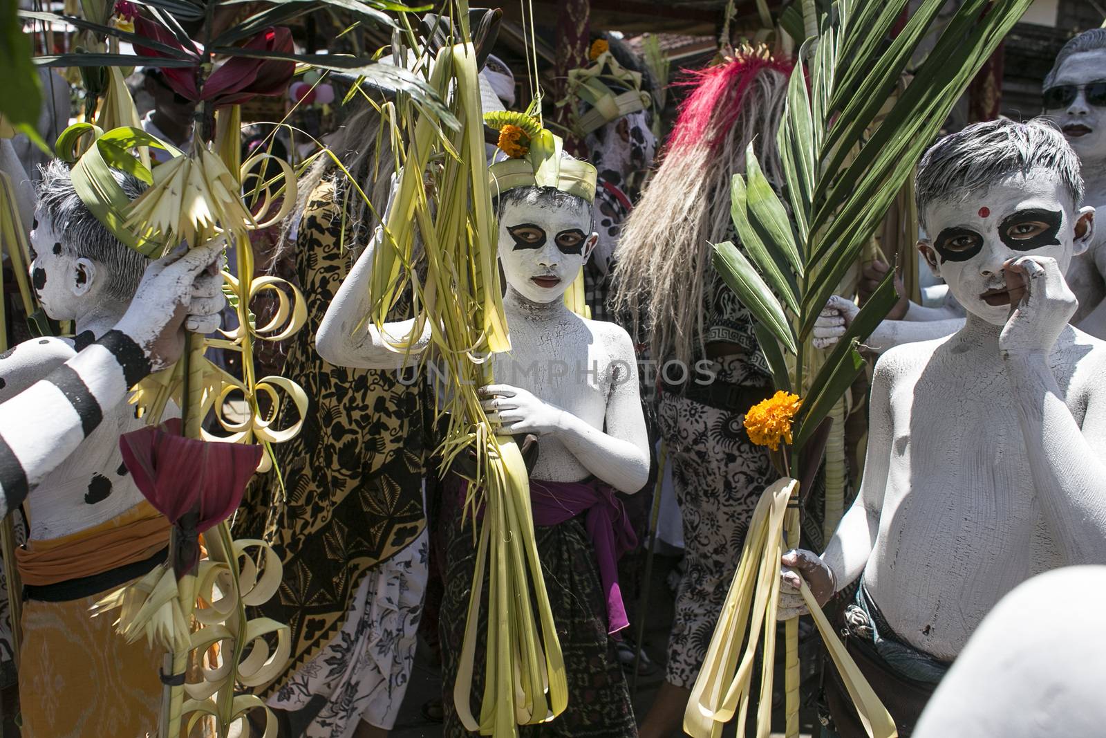 INDONESIA, Gianyar, Bali: Young members of the village community walk around the village with their bodies painted during the Grebeg ritual, on March 16, 2016, in Tegallalang village, Gianyar, Bali, Indonesia. During the biannual ritual, young members of 