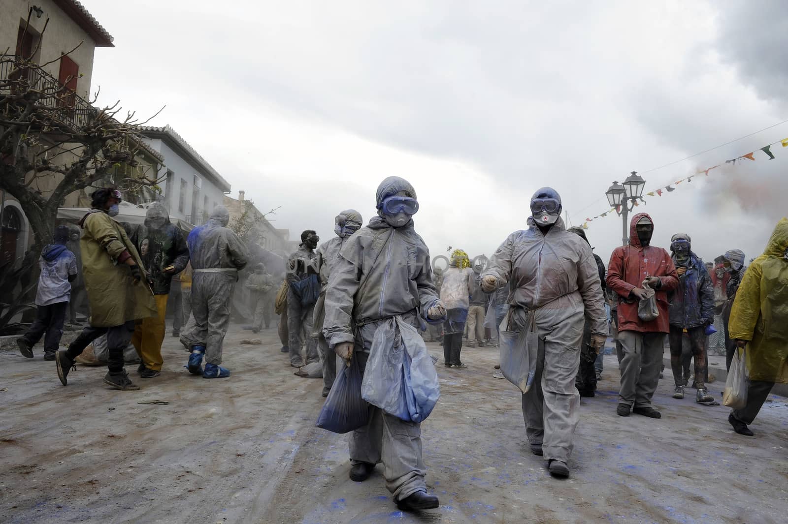 GREECE, Galaxidi: People walk through Galaxidi holding bags of flour on March 14, 2016. The battle takes place every year on 'Clean Monday', which marks the beginning of the Christian lent festival.The coastal town has observed this festive event which dates back to the mid 19th century. 
