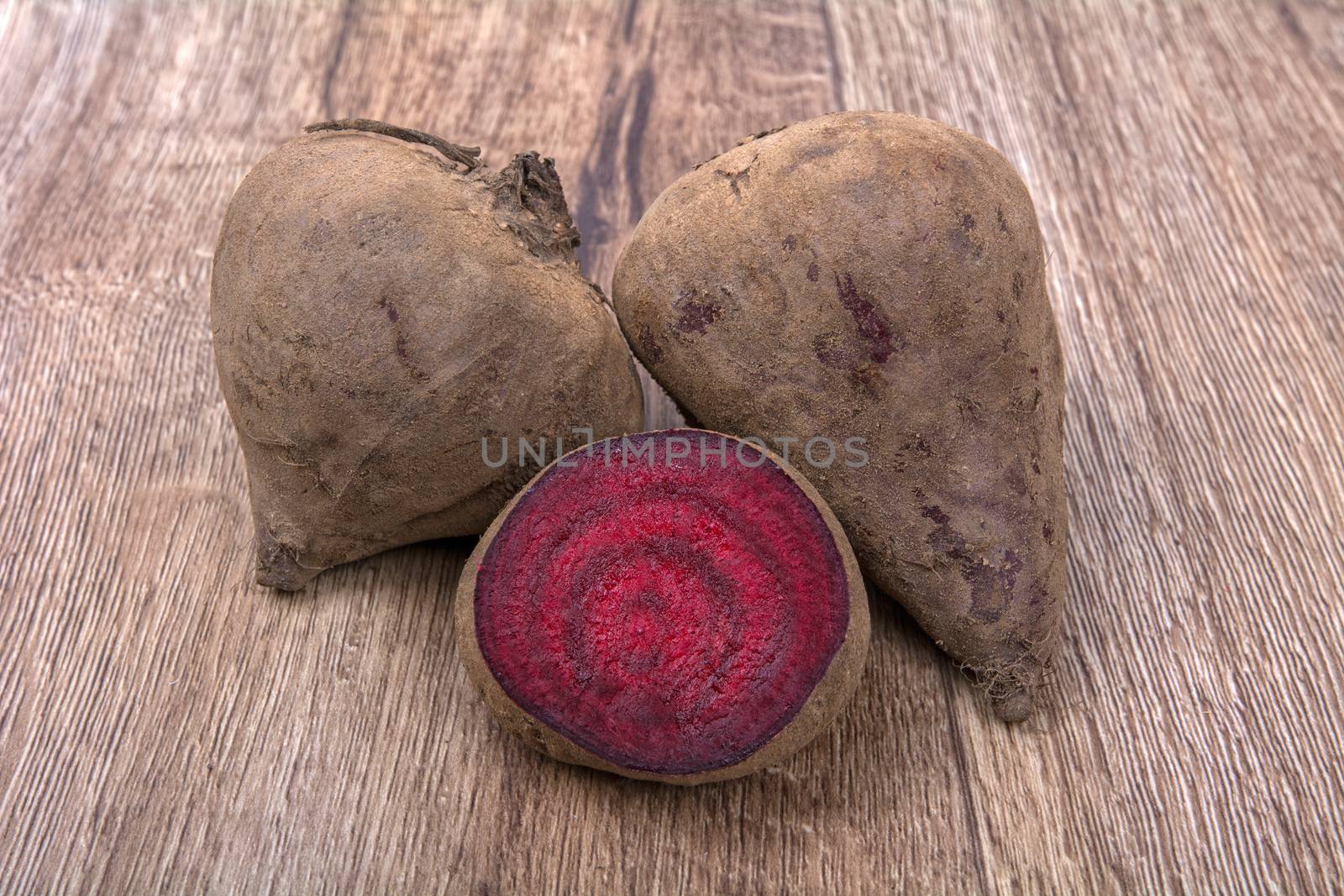 The red beets on a brown wooden background