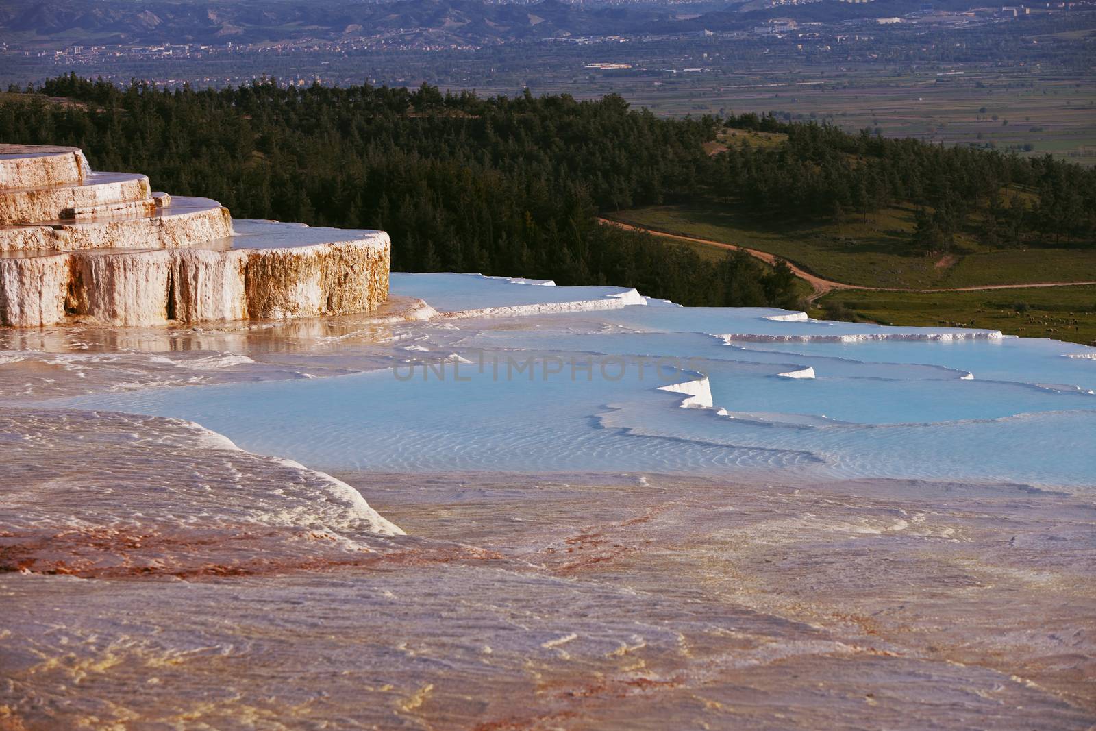 Pamukkale mineral pools overlooking valley and pine forest in Turkey
