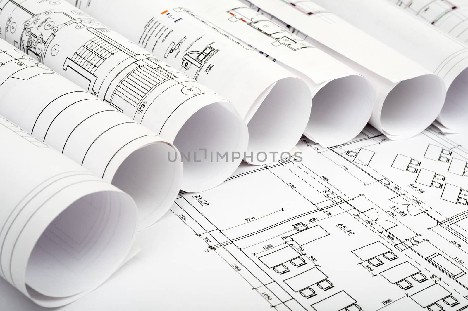 Rolls of blueprints, side view. Building concept