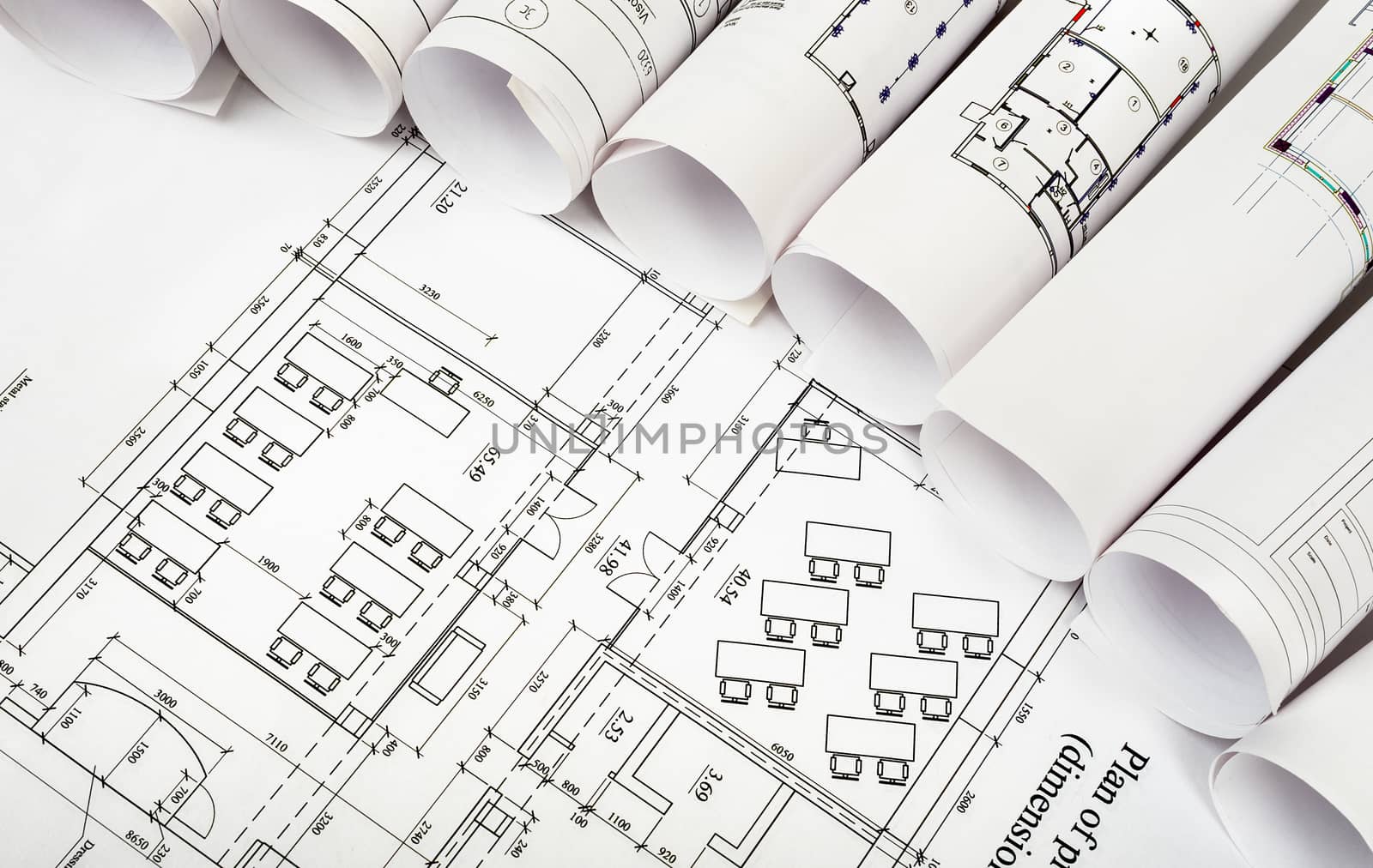 Blueprints and rolls of blueprints, side view. Building concept