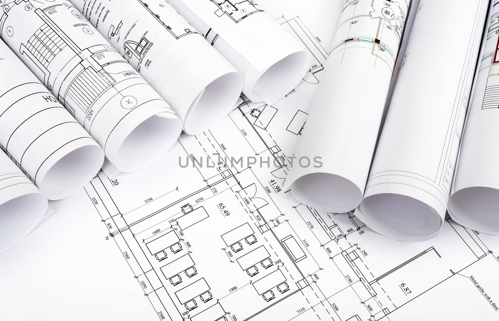 Blueprints and rolls of blueprints, top view. Building concept