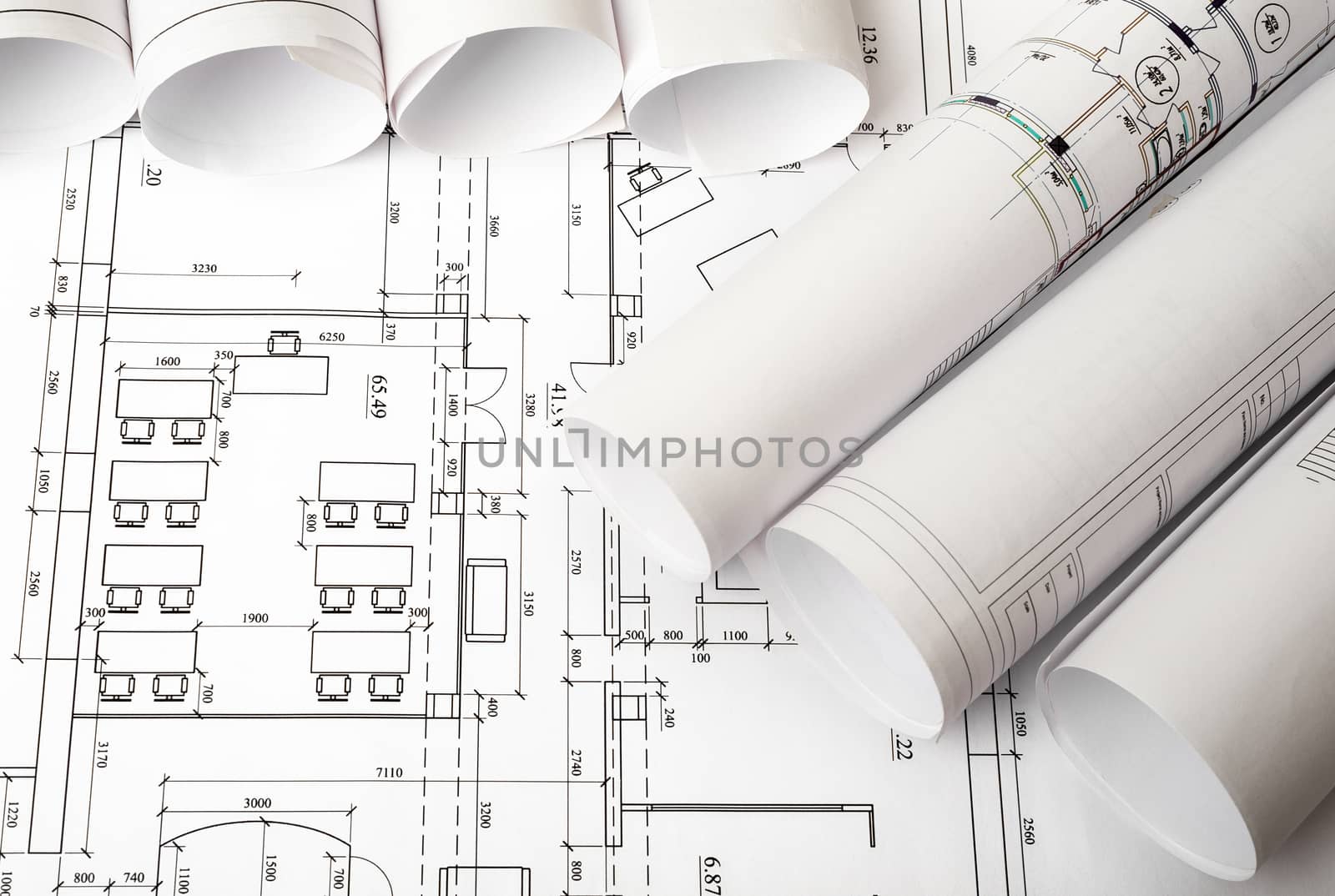 Blueprints and rolls of blueprints, top view. Building concept