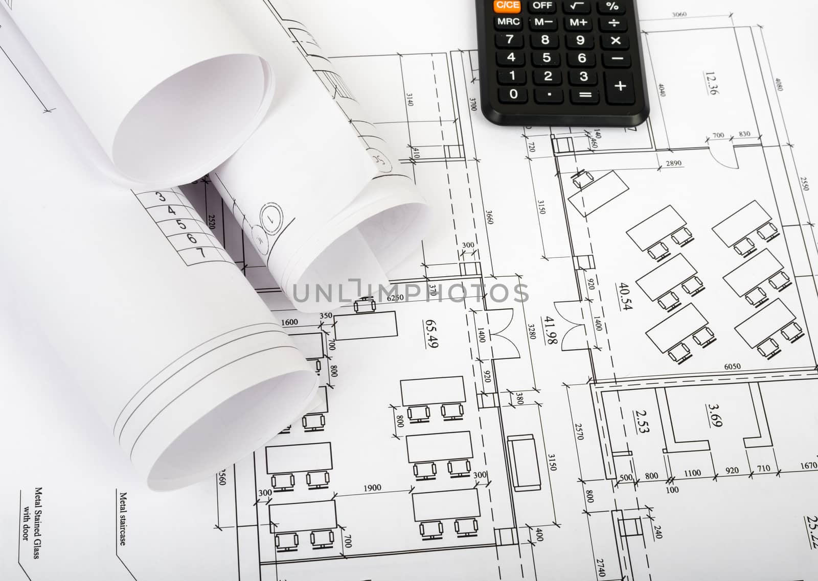 Architecture plan and rolls of blueprints with calculator. Building concept