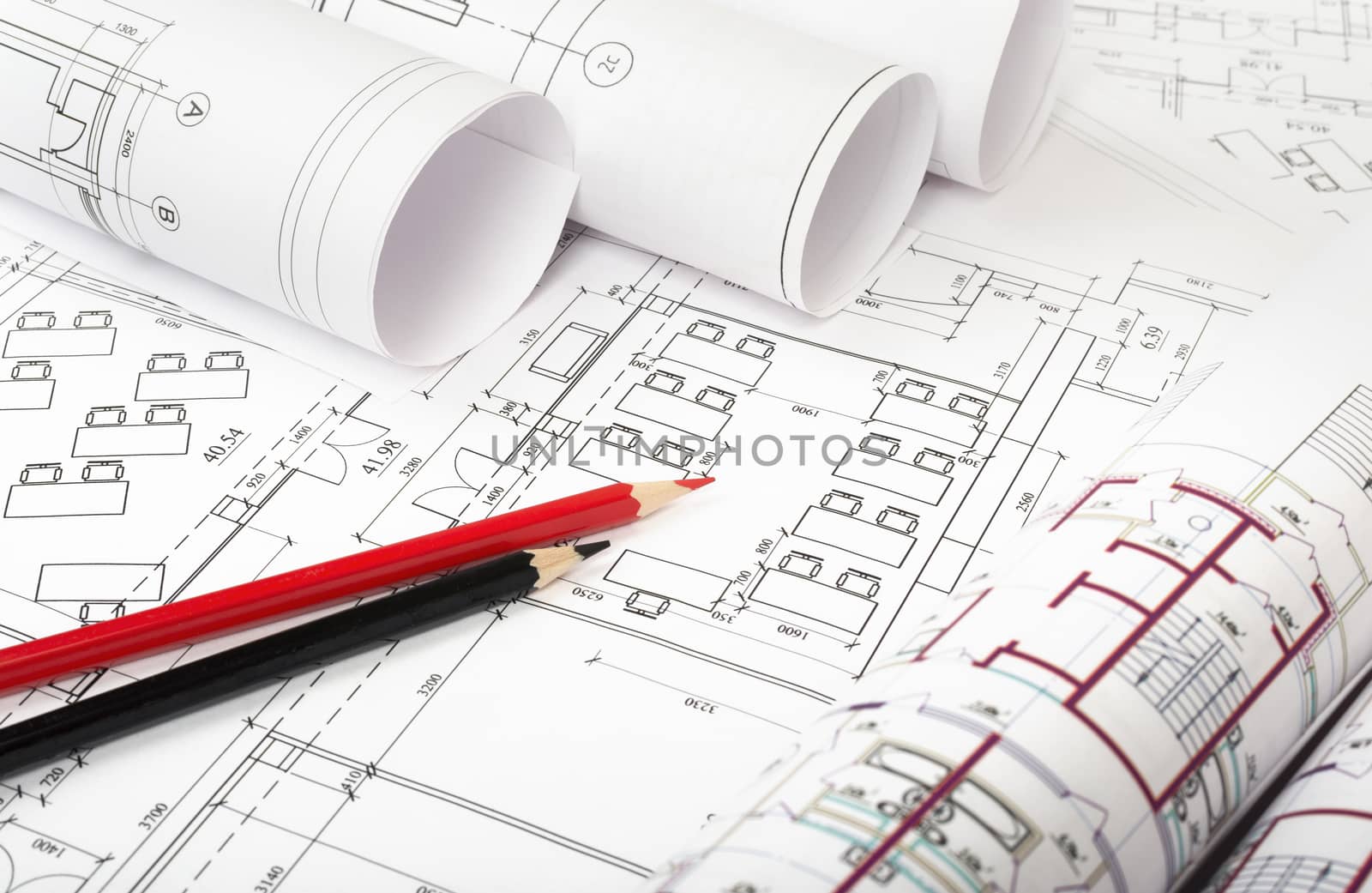 Architecture plan and rolls of blueprints with crayons. Building concept