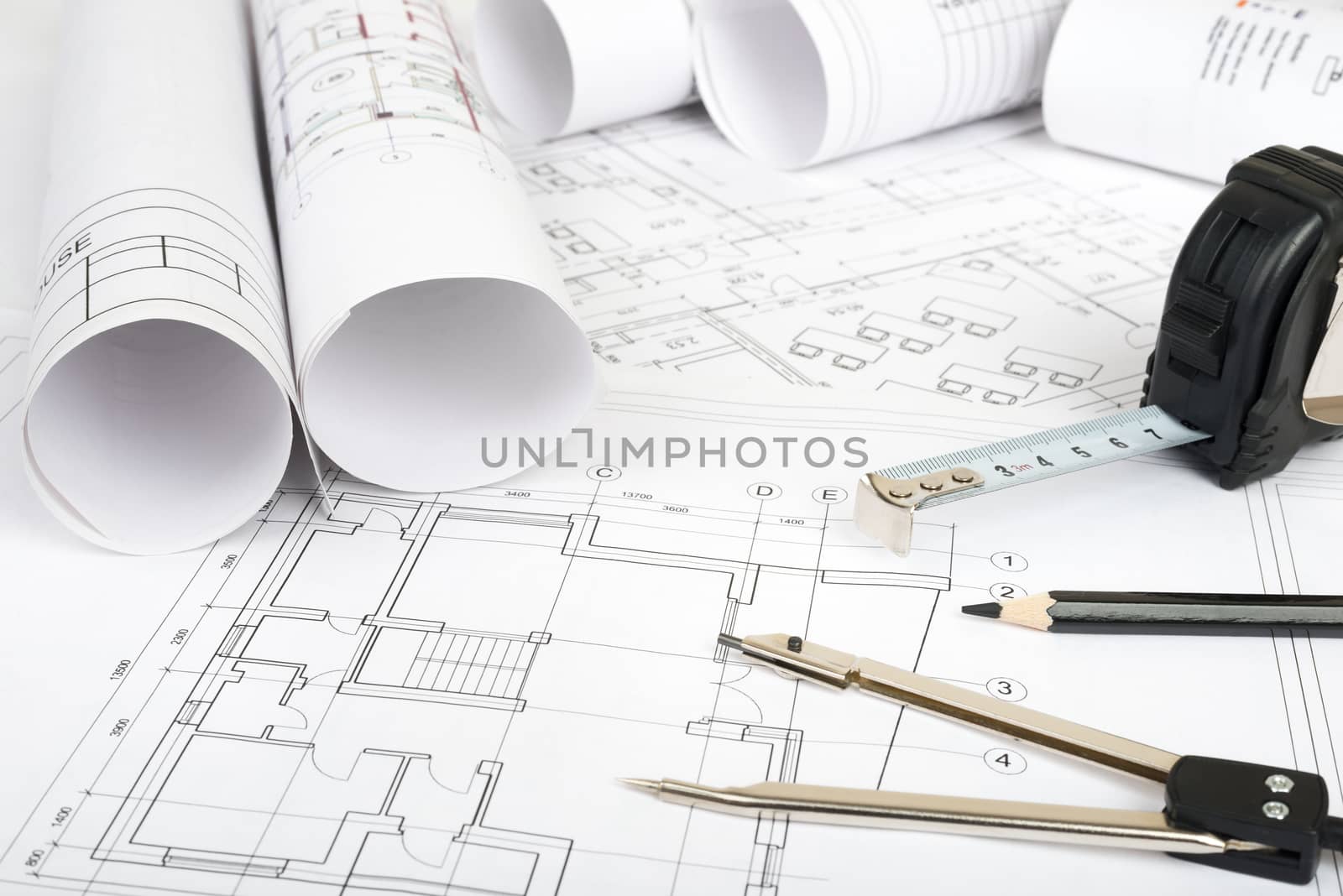 Architecture plan and rolls of blueprints with meter. Building concept