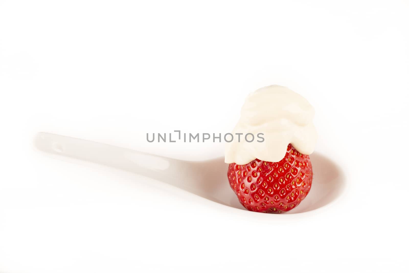 strawberry with cream vanilia in white spoon white background France