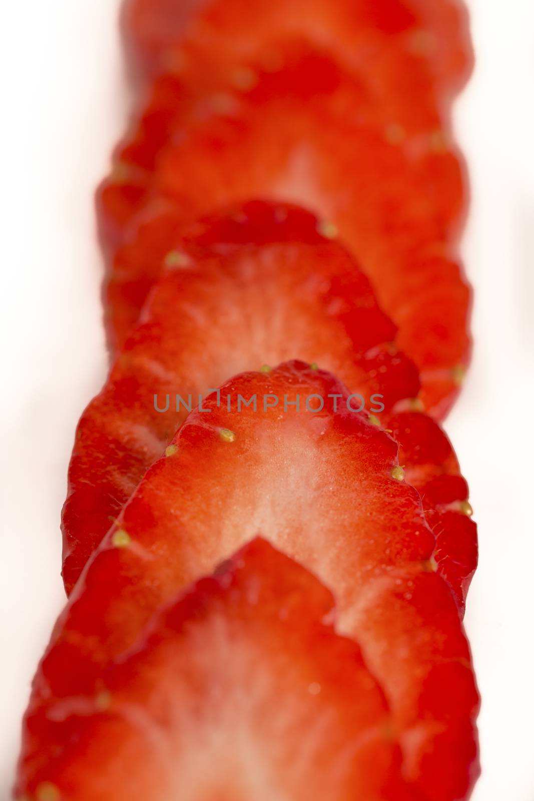 sliced strawberries in white plate white background France