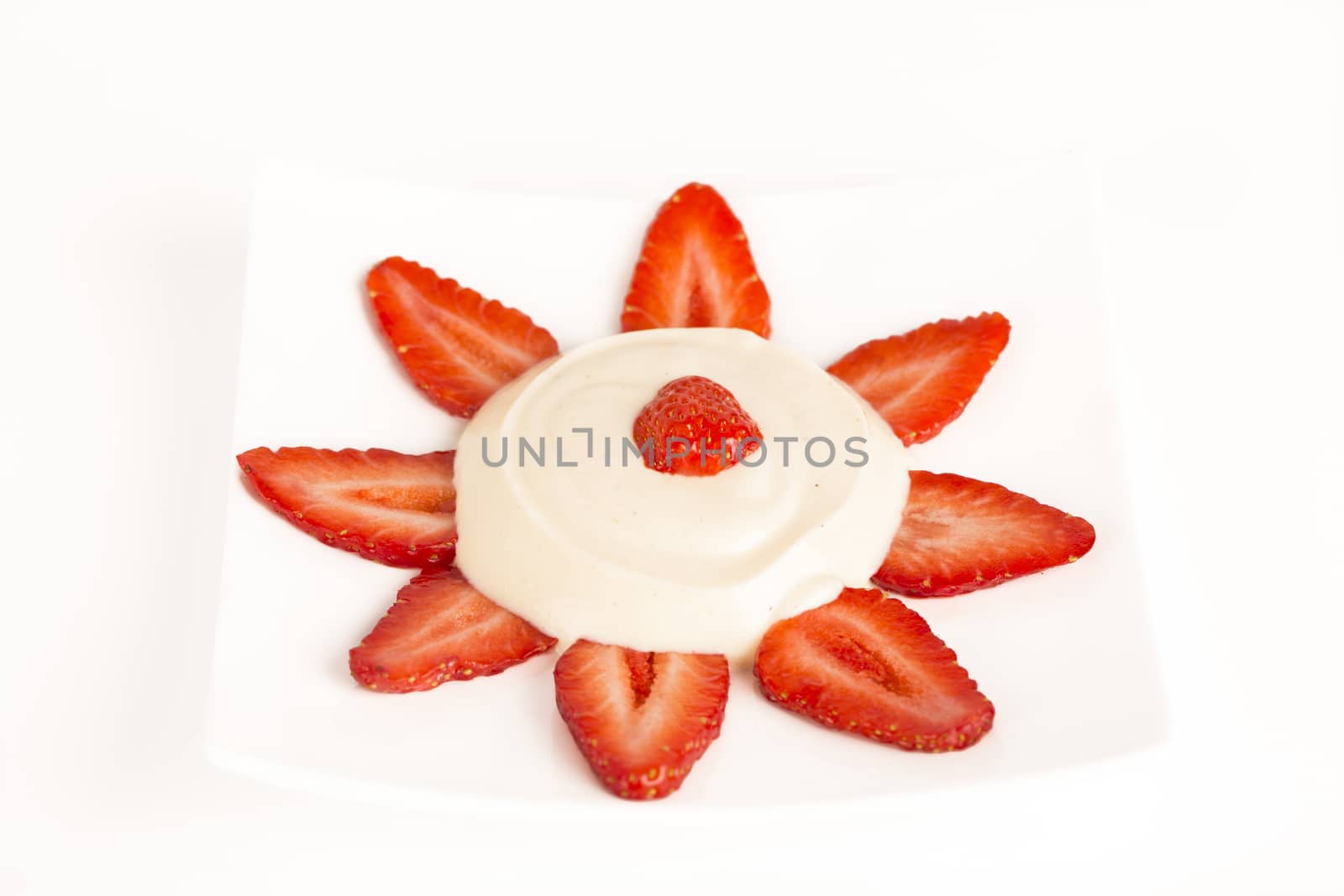 Sun Strawberrues slices with vanilia cream on white background France