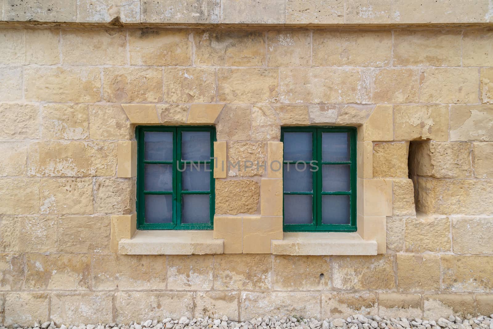 Detailed view of Valletta city in Malta island with limestone buildings from medieval times, on cloudy sky background.