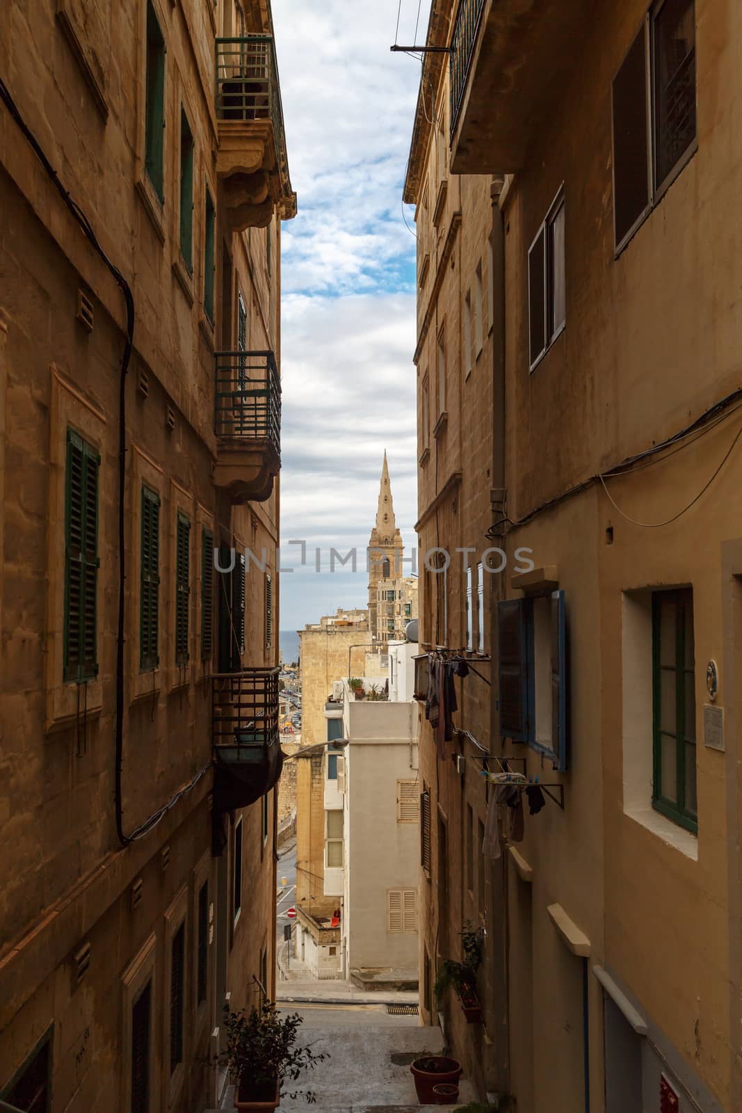Detailed view of Valletta city in Malta island with limestone buildings from medieval times, on cloudy sky background.