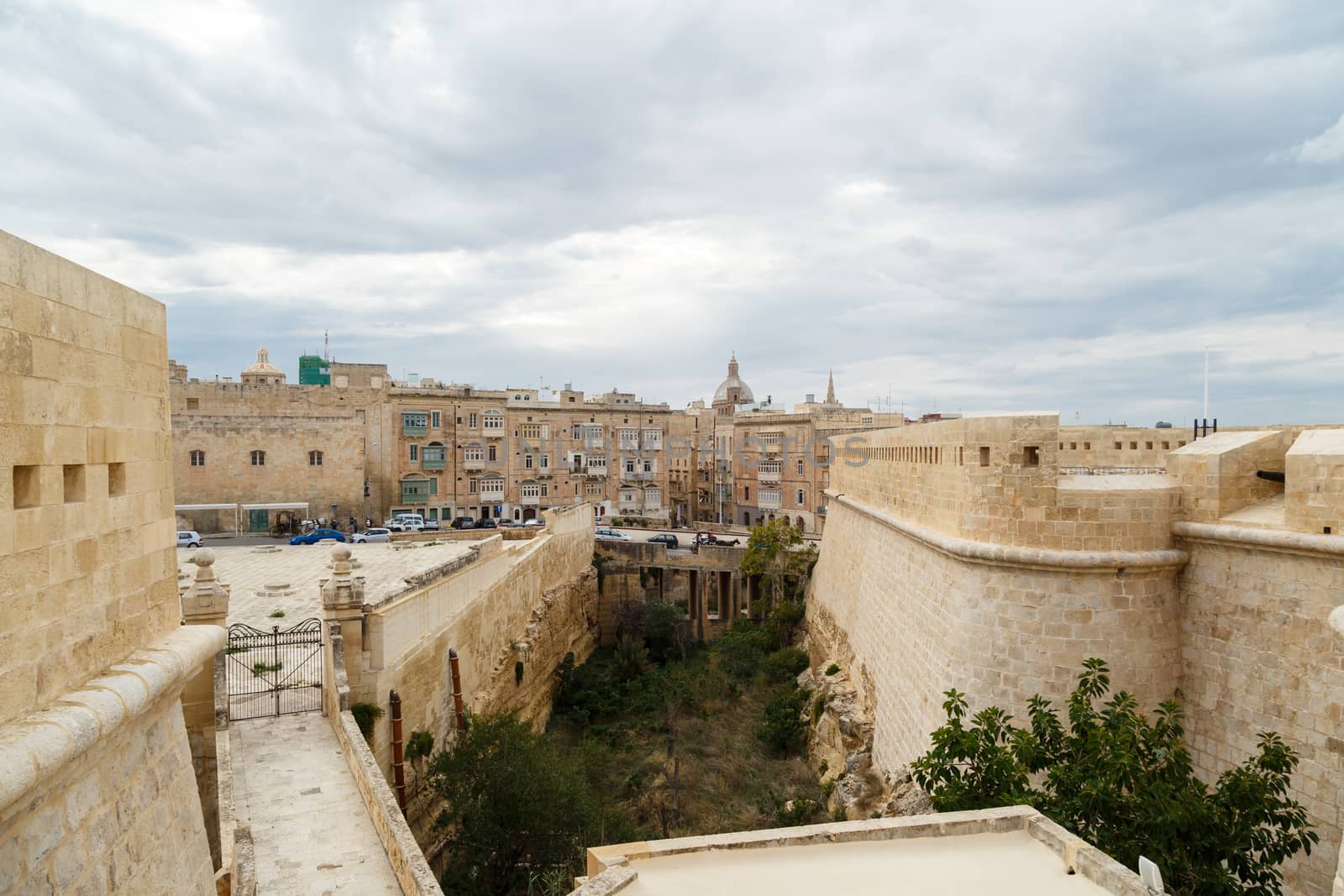 VALLETTA, MALTA - OCTOBER 30, 2015 : View of National War Museum in Valletta, Malta with high yellow stone walls, on cloudy sky background.