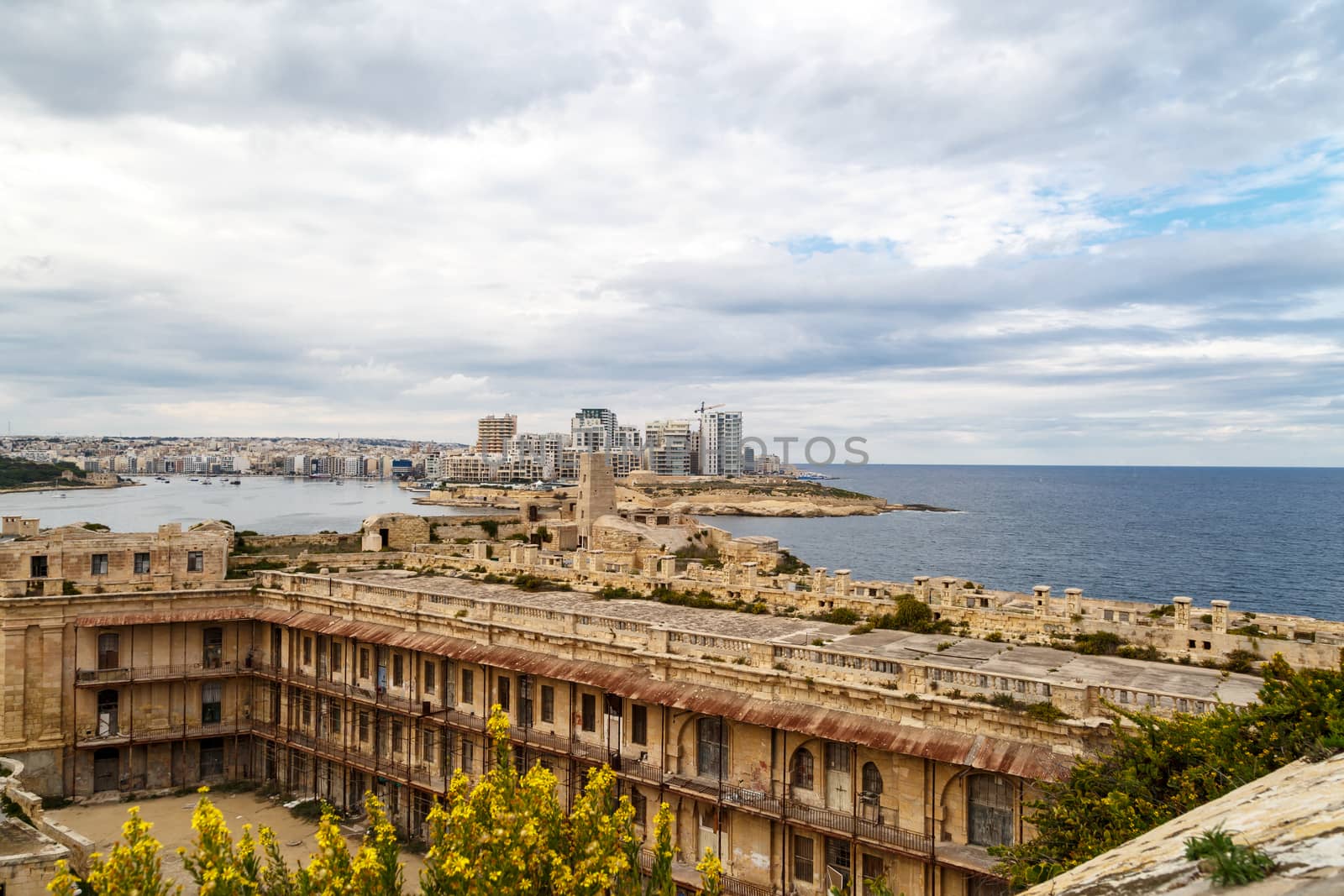 General view of Valletta, Malta island with seascape, port and historical limestone buildings from medieval times.
