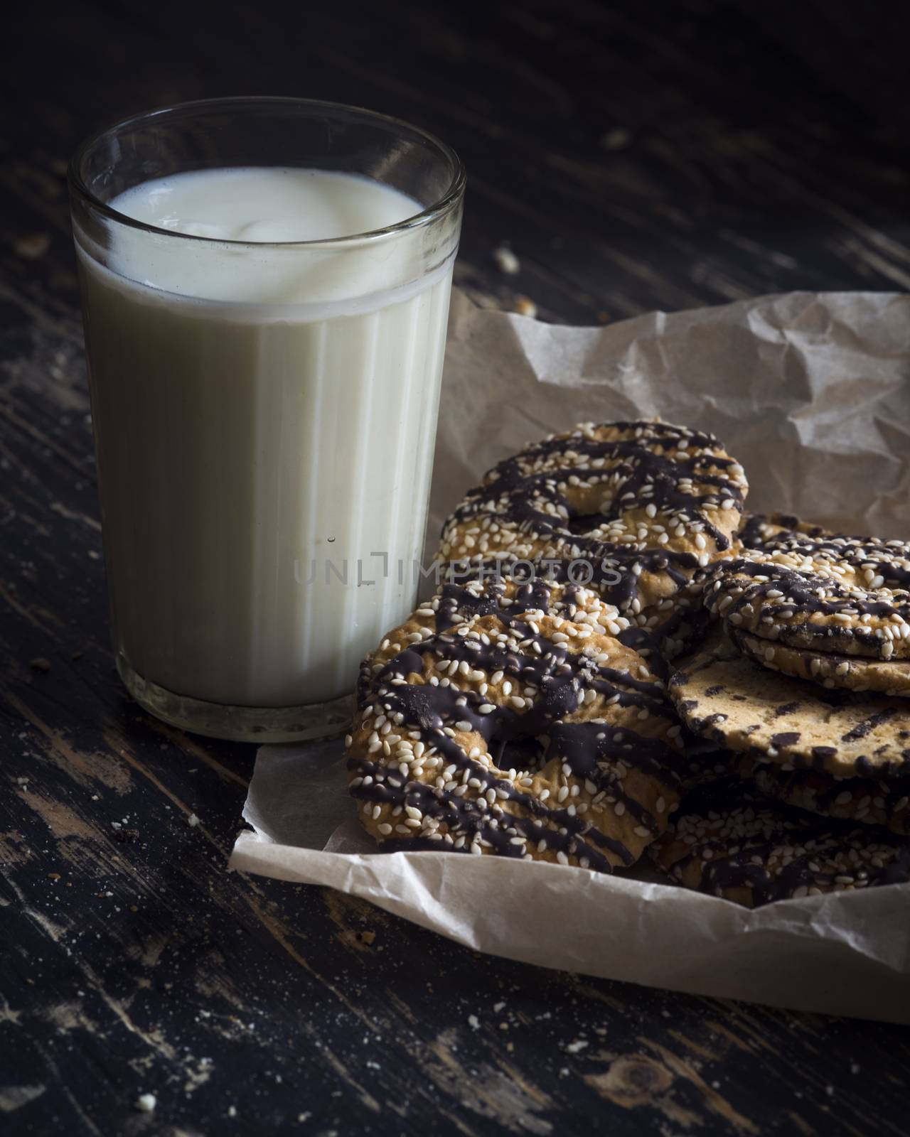 Milk and Cookies on a dark wood background