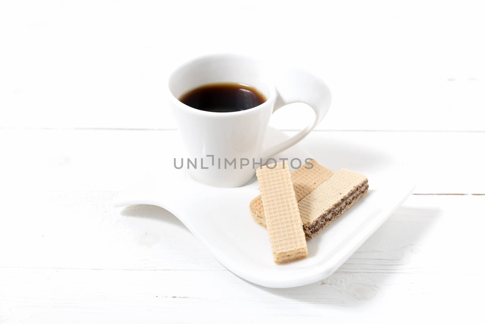 coffee cup with wafer on white wood background