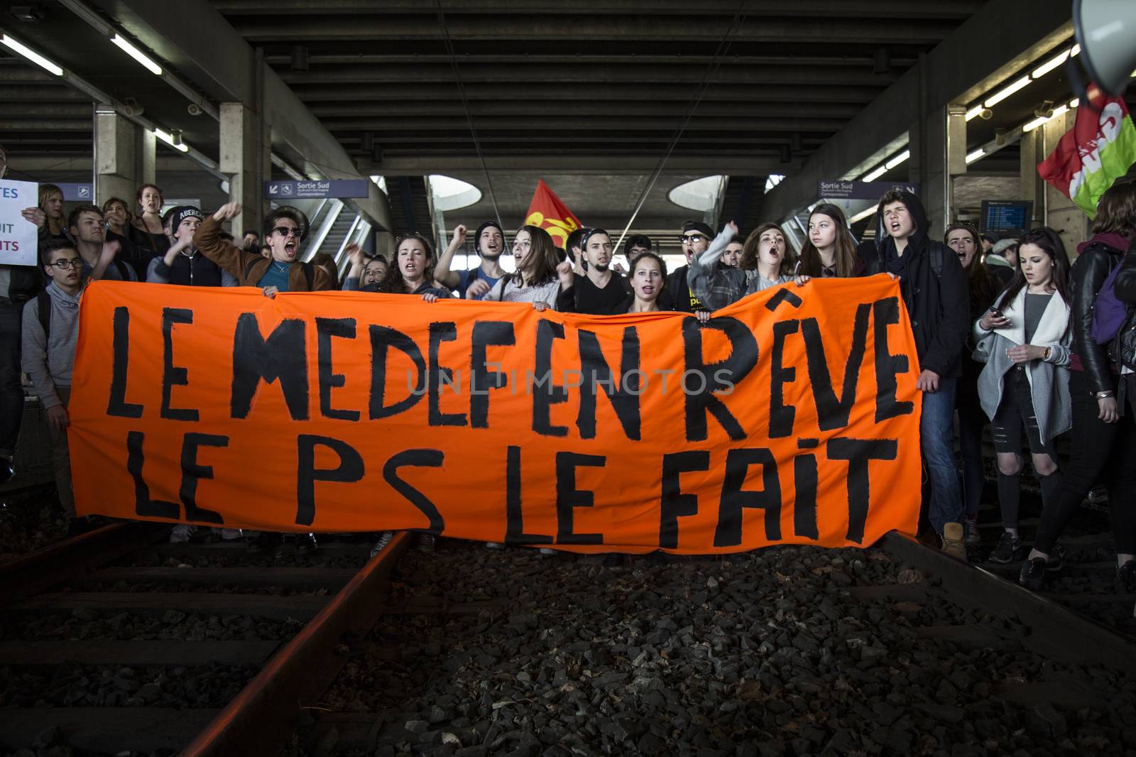 FRANCE, Paris: High school students and youths demonstrate on the rail tracks of Rennes' railway station, western France,  during a protest march opposing the government's labour reforms on March 17, 2016. The contested reform is designed to inject more flexibility into the labour market by dropping key measures that would have benefited smaller companies. In a significant change from the original text, French Prime minister said on Monday that small and medium-sized companies would not be able to unilaterally introduce flexible work practices into their working week.