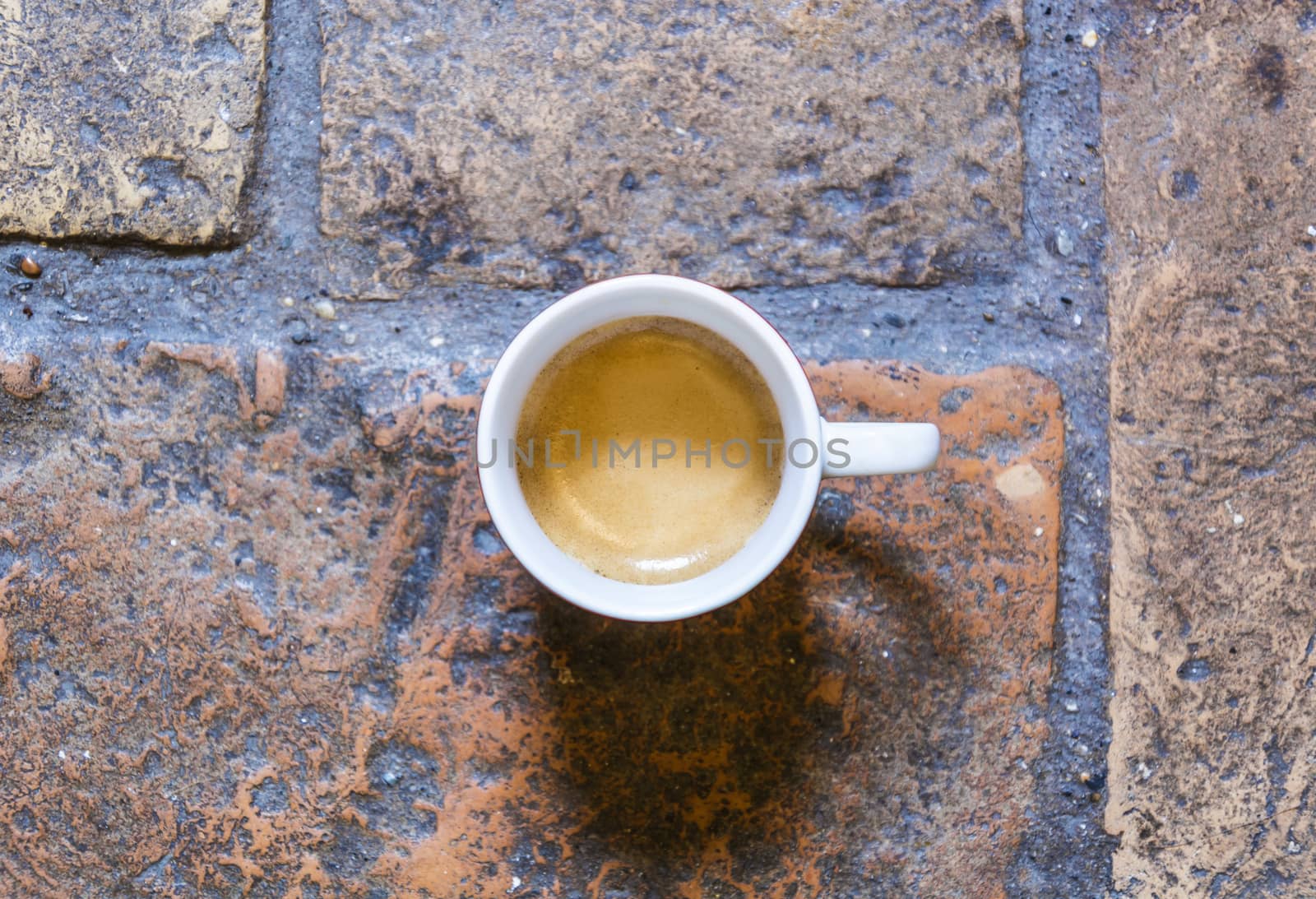cup of coffee on a rustic floor by rarrarorro