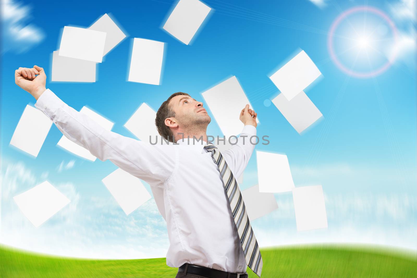 Businessman with paper looking up, freedom concept