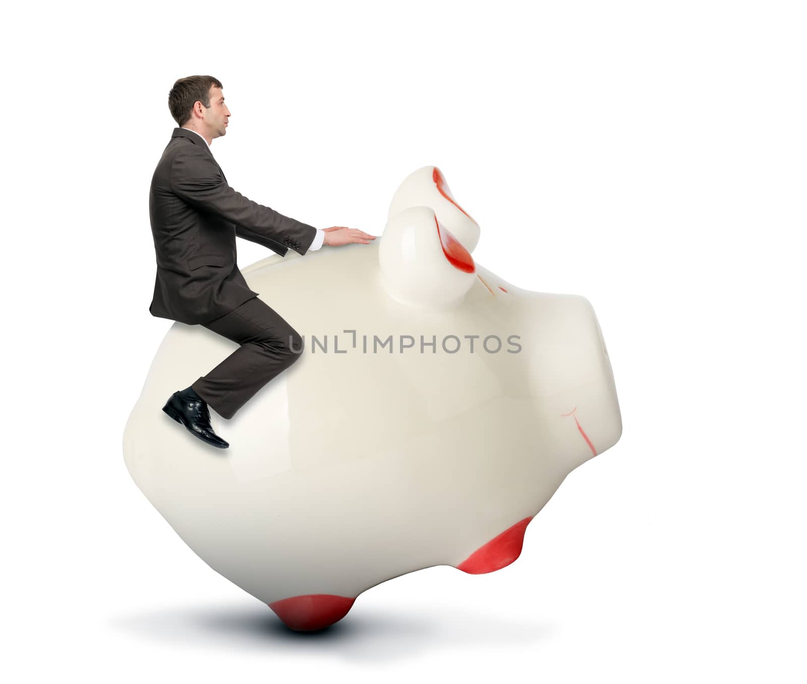 Businessman riding piggy bank by cherezoff