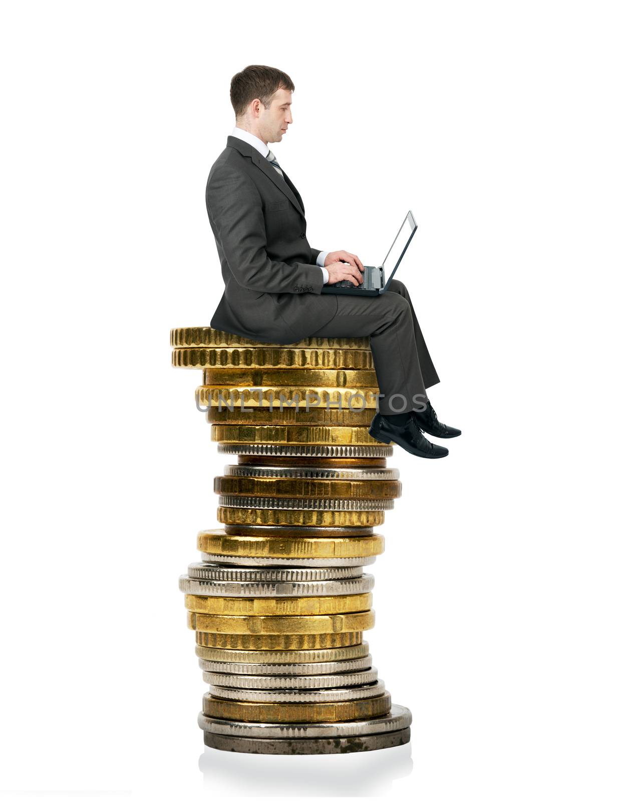 Businessman sitting on  coins isolated on white background