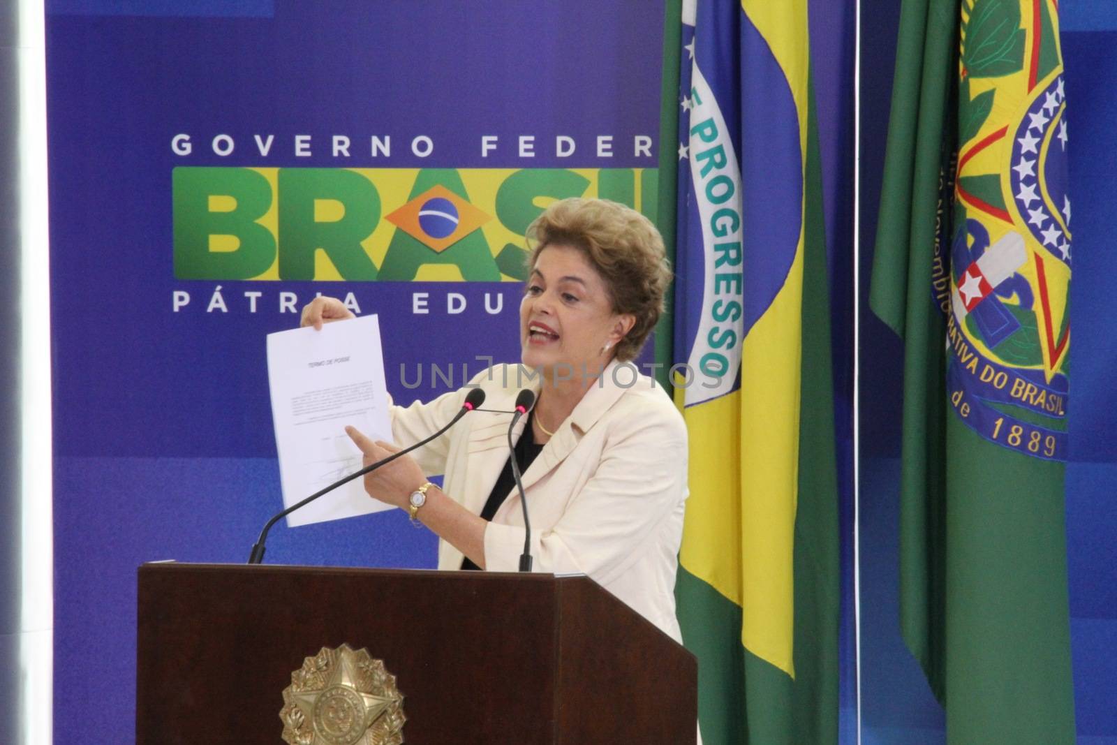 BRAZIL, Brasilia: President Dilma Rousseff holds up a document during a ceremony to appoint former President Luiz Inácio Lula da Silva to the cabinet on March 17, 2016 in Brasilia.The decision resulted in protests throughout the country, with some thinking that the appointment of the former president was an attempt to save him from charges in a corruption scandal.