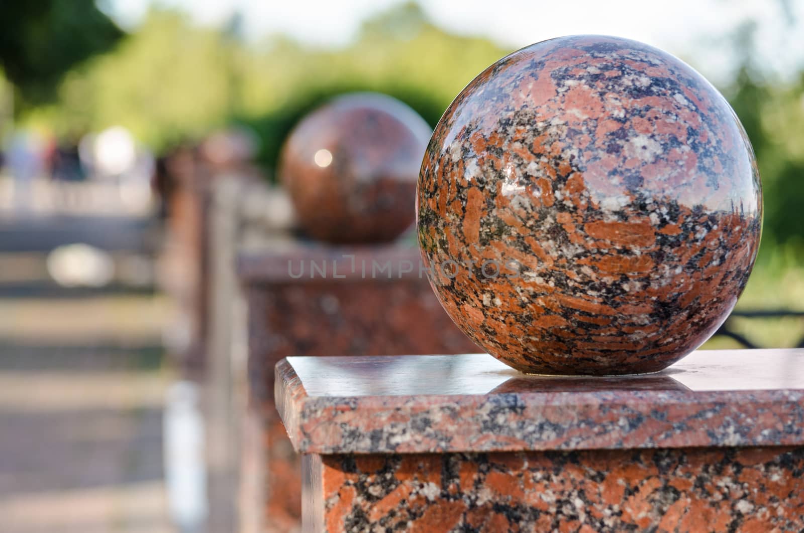 Granite balls on fence in urban Park