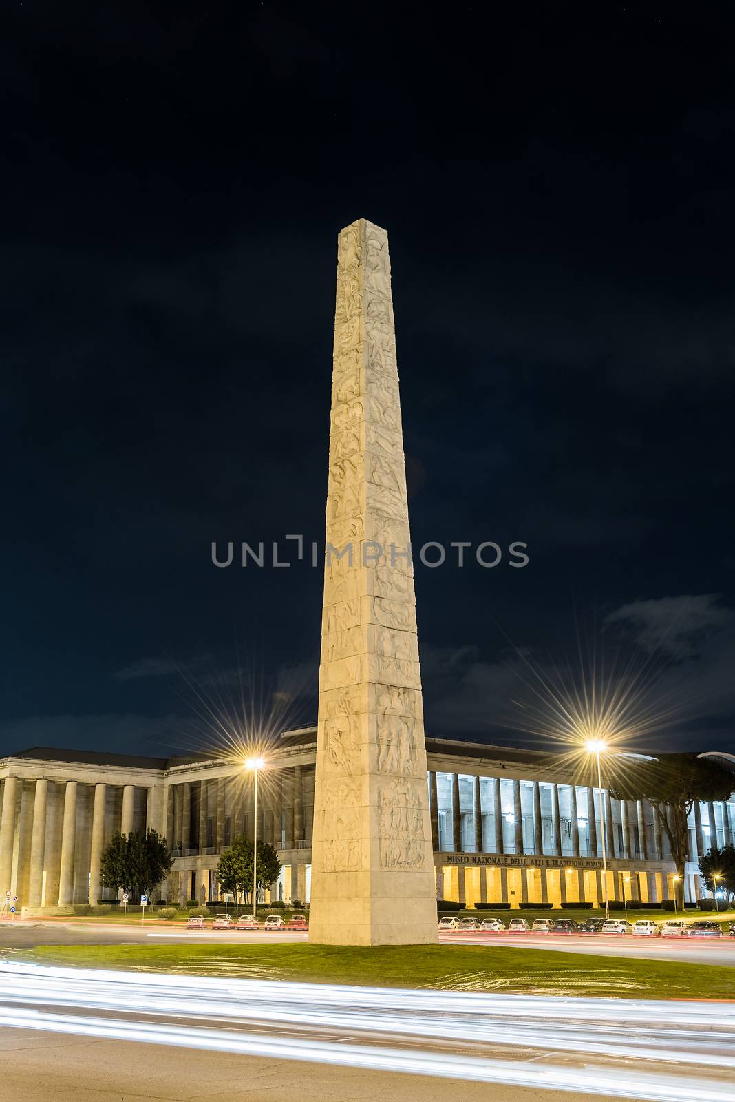 Night view of the Marconi obelisk, iconic landmark in the EUR district, Rome, Italy