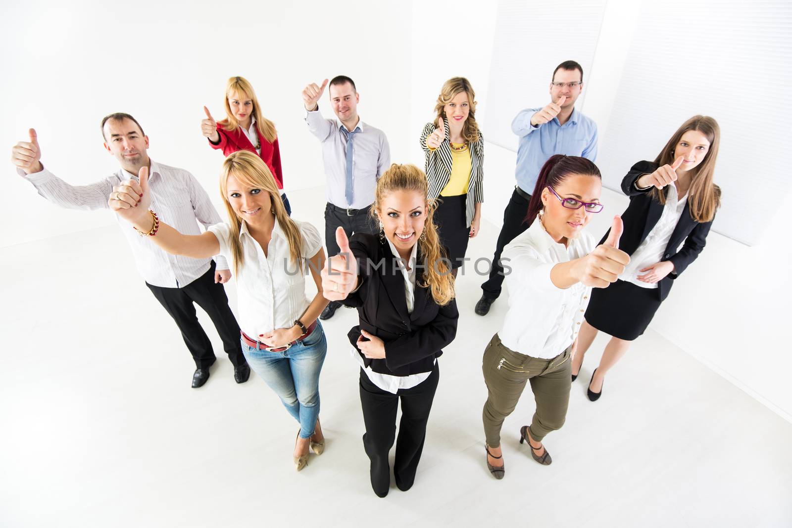 Group of a Successful Business People Showing Thumbs Up and looking at the camera.