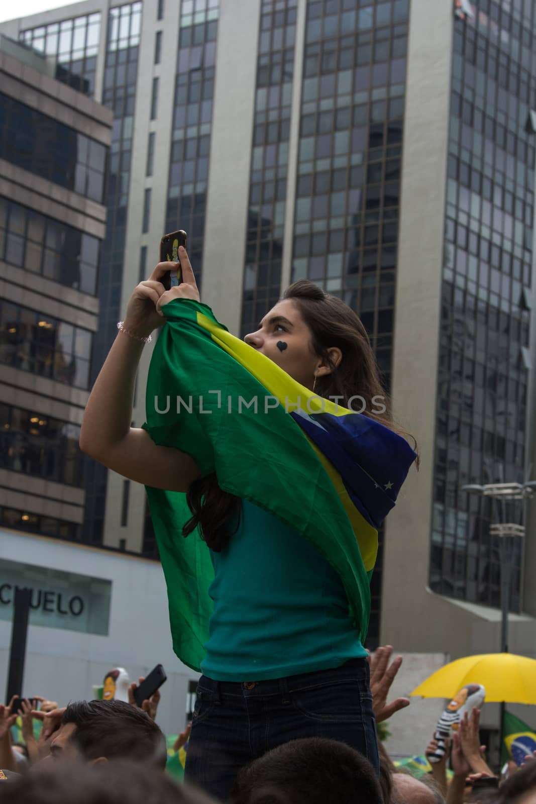 Sao Paulo Brazil March 13, 2016: One unidentified girl taking a selfie in the biggest protest against federal government corruption in Sao Paulo.