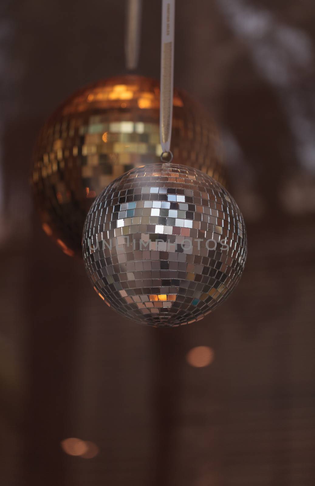 Silver and gold disco balls hang from the ceiling on New Years eve