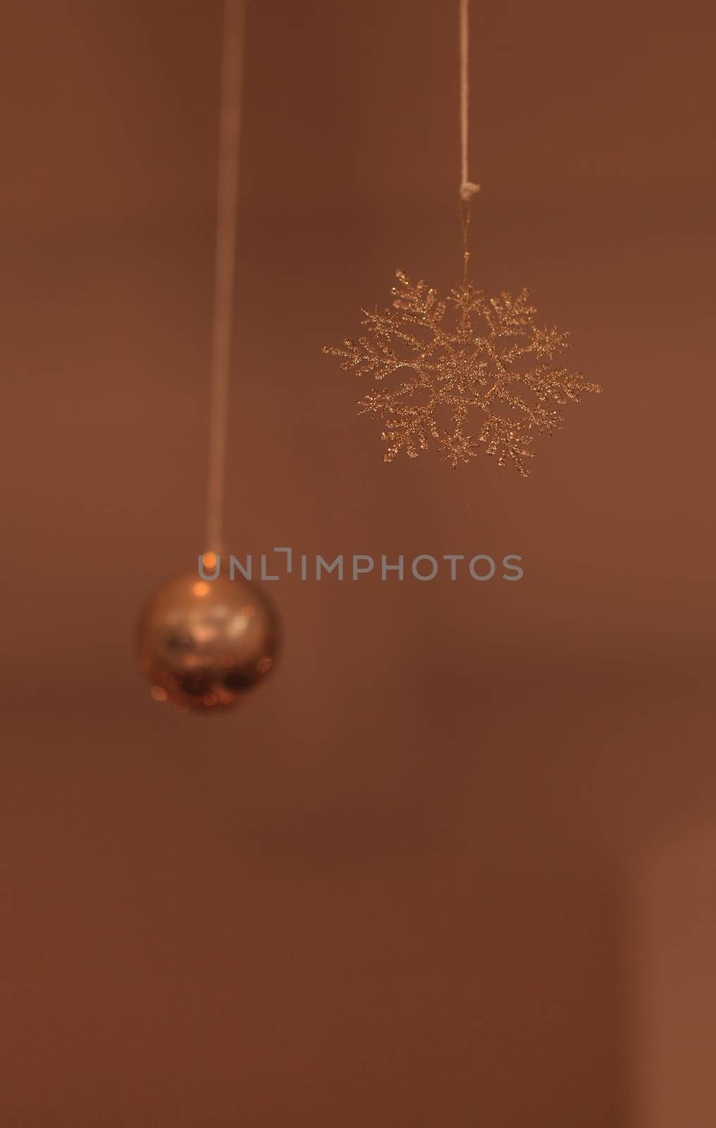 Gold silver Christmas ornament hanging from the ceiling in December