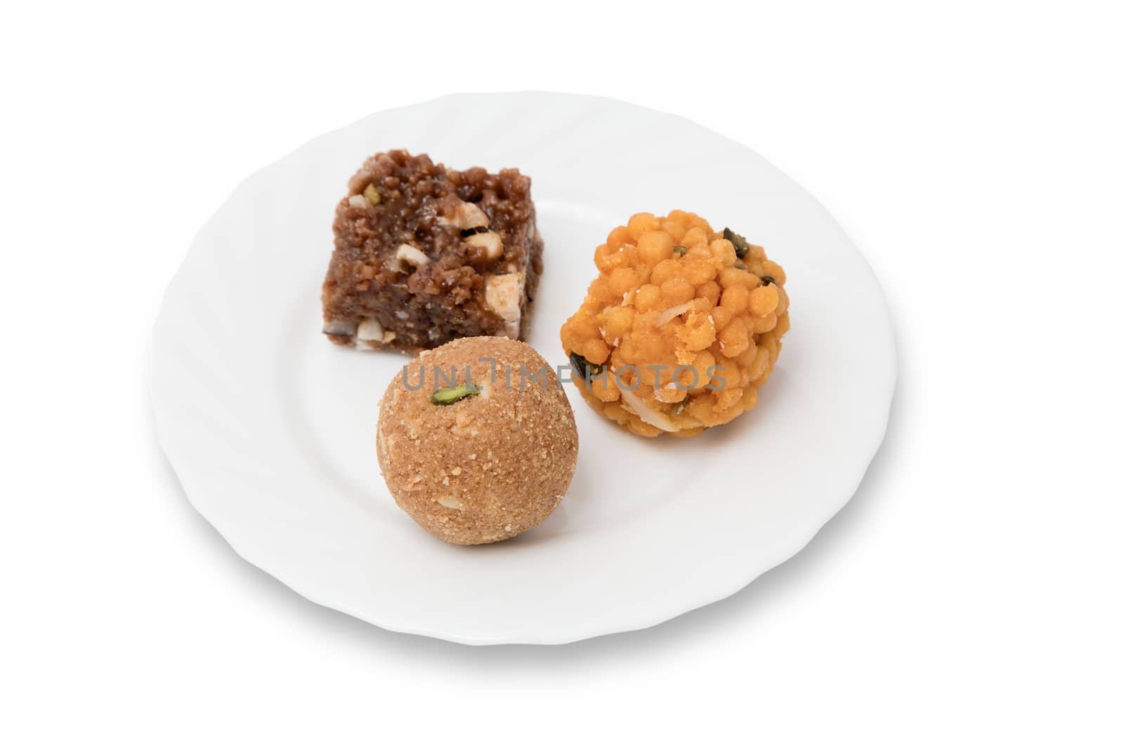 Indian sweets on a plate isolated over white