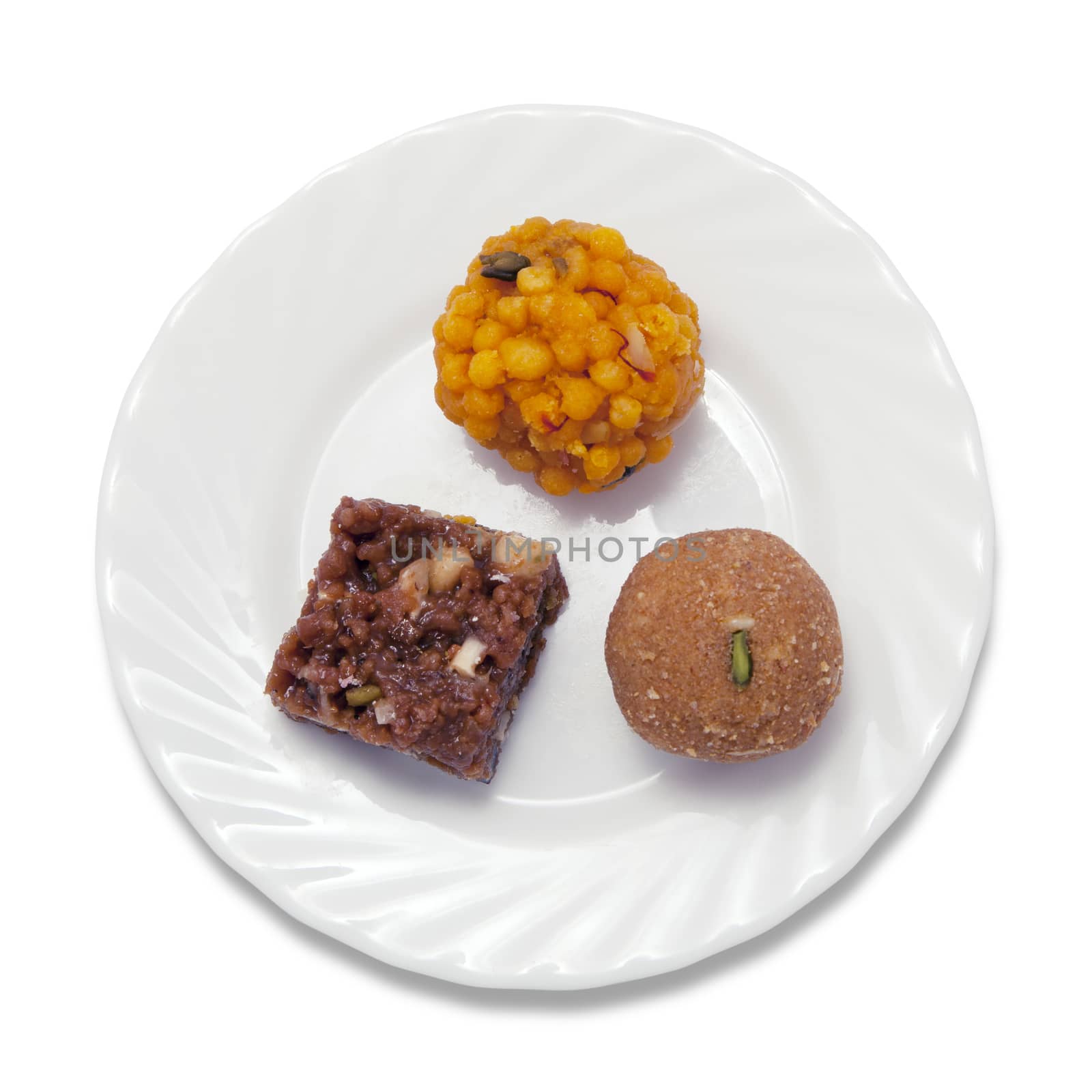 Indian sweets on a plate isolated over white