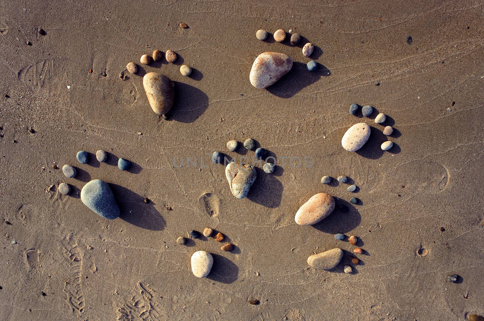 Group of foot by pebble on sand background, amazing concept from stone  with yellow color on beach, awesome art product
