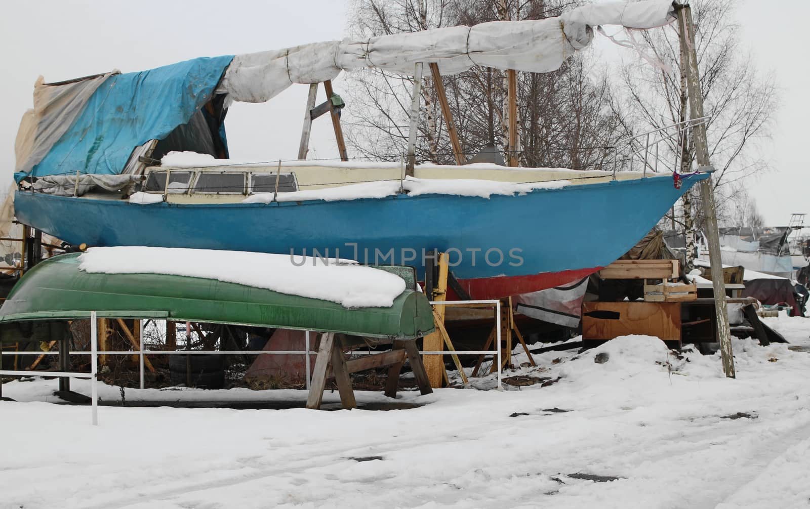 old boat and  yacht lying on the shore