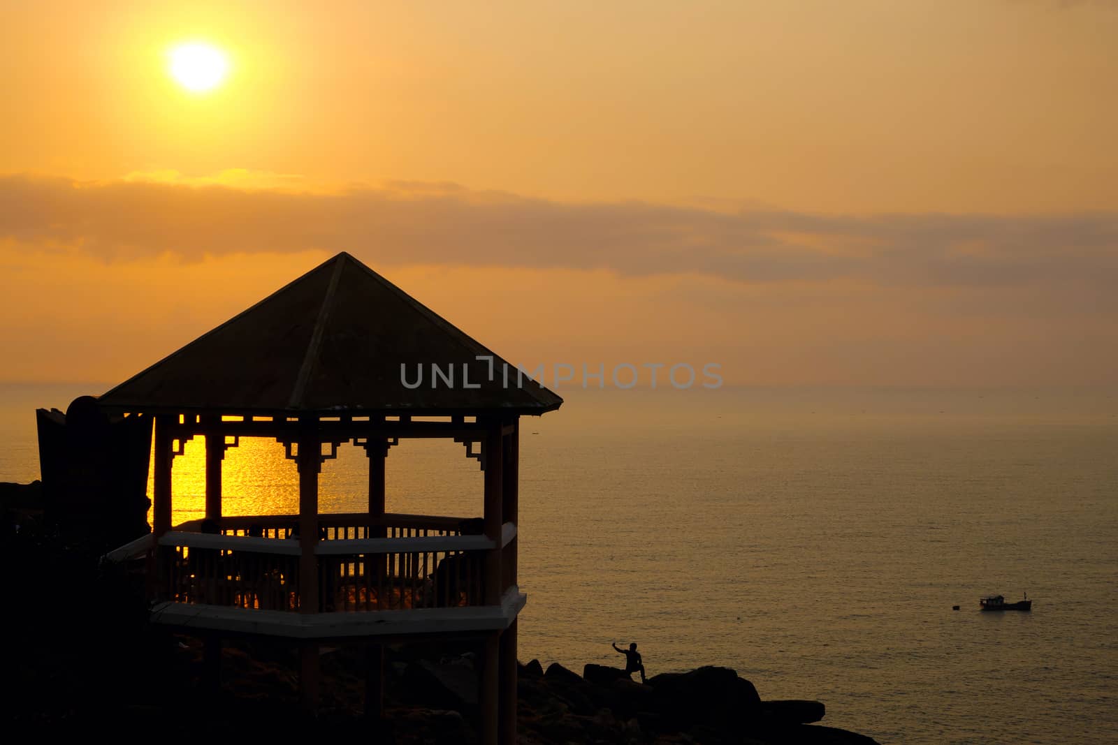 Silhouette of watch tower and people in morning at Dai Lanh cape, Mui Dien, Phu Yen, Viet Nam, yellow sun in sunrise make beautiful scene, this place catch the first sunlight in Vietnam country 