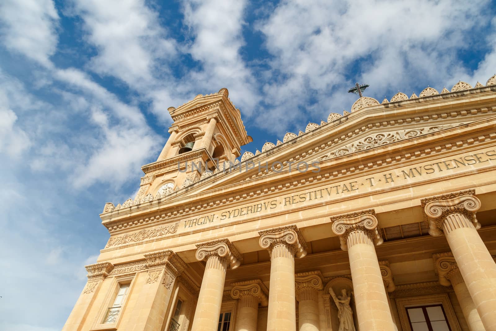 MOSTA, MALTA - NOVEMBER 1, 2015 : Exterior view of Rotunda of Malta known as also Mosta Dome, historical and the third biggest church in Europe, on cloudy blue sky background.