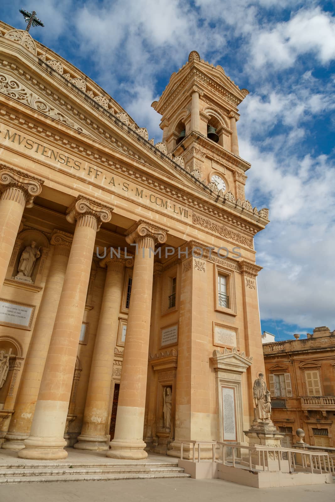 MOSTA, MALTA - NOVEMBER 1, 2015 : Exterior view of Rotunda of Malta known as also Mosta Dome, historical and the third biggest church in Europe, on cloudy blue sky background.