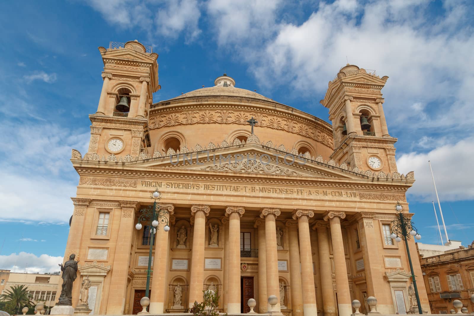 MOSTA, MALTA - NOVEMBER 1, 2015 : Exterior view of Rotunda of Malta known as also Mosta Dome, historical and the third biggest church in Europe, on cloudy blue sky background.