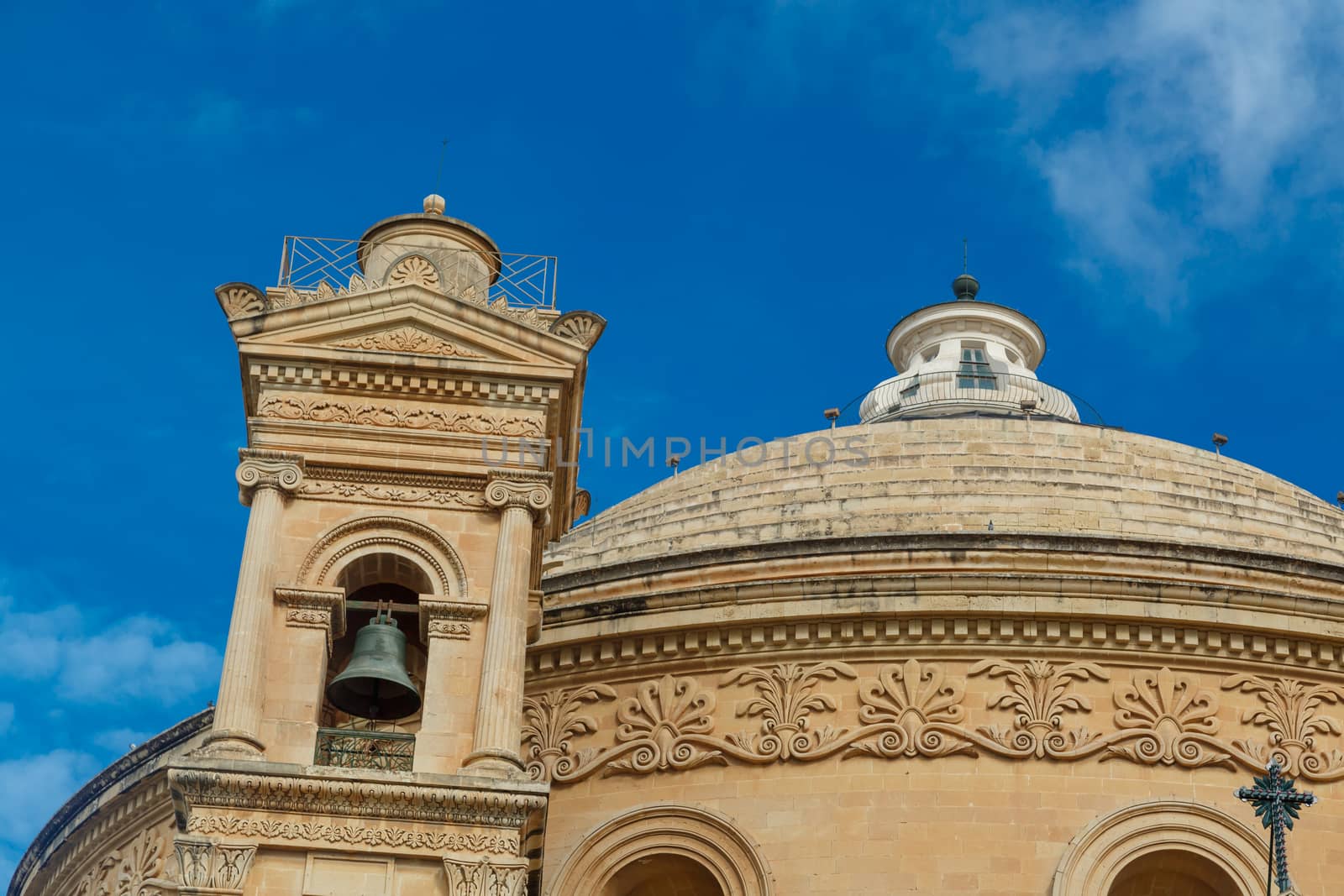 MOSTA, MALTA - NOVEMBER 1, 2015 : Exterior view of Rotunda of Malta known as also Mosta Dome, historical and the third biggest church in Europe, on cloudy blue sky background.
