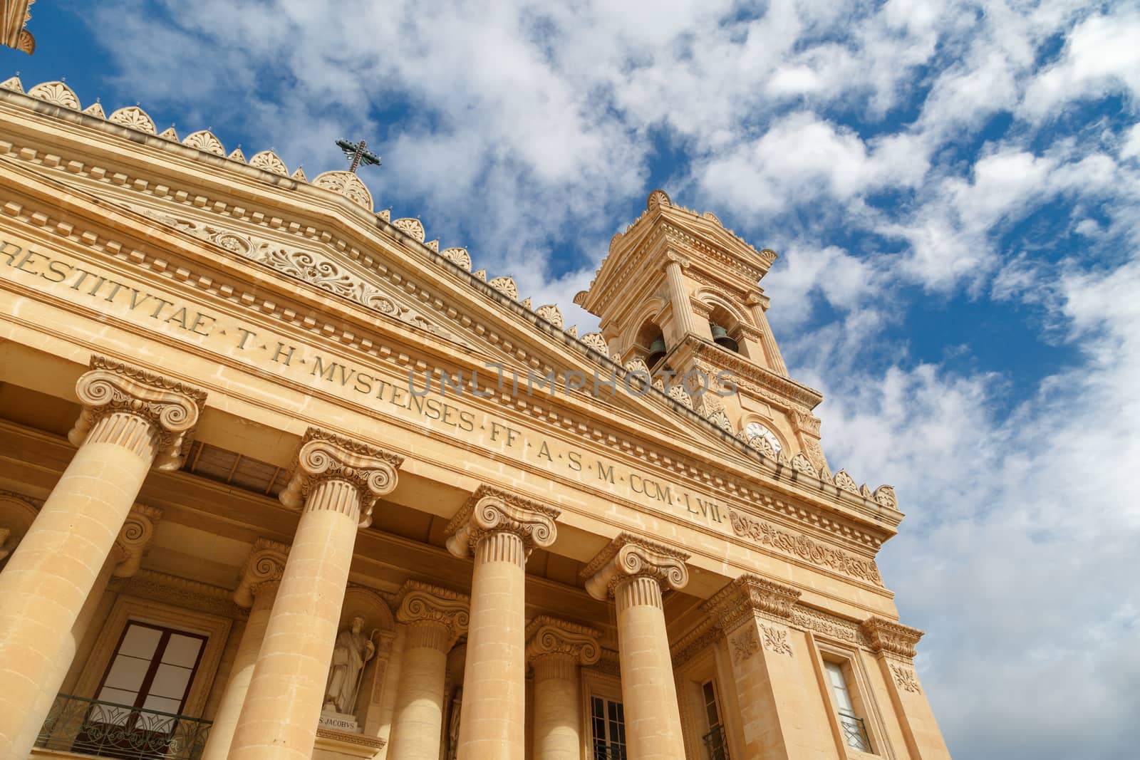MOSTA, MALTA - NOVEMBER 1, 2015 : Exterior view of Rotunda of Malta known as also Mosta Dome, historical and the third biggest church in Europe, on cloudy blue sky background.