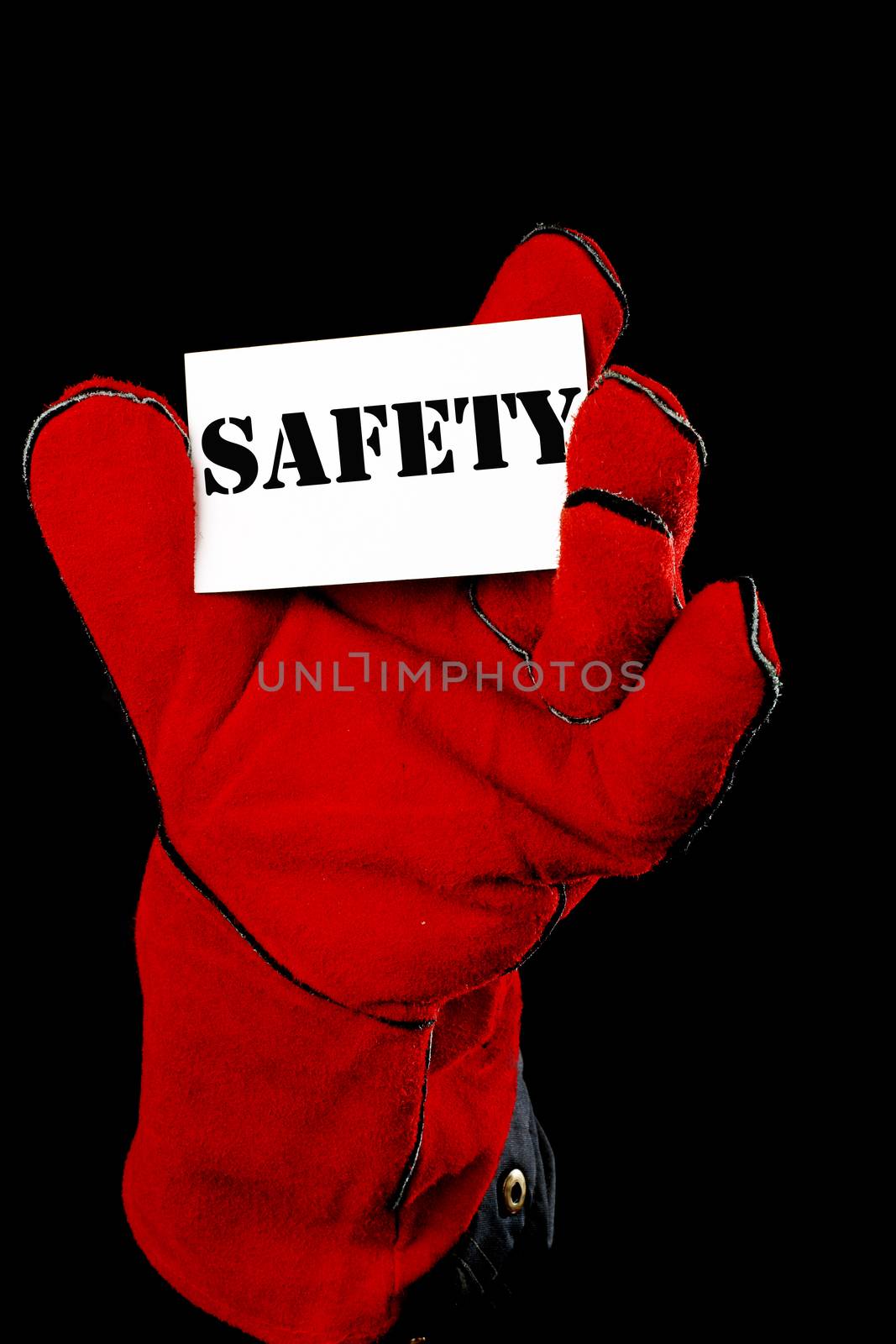 worker holding a card  with the inscription SAFETY 