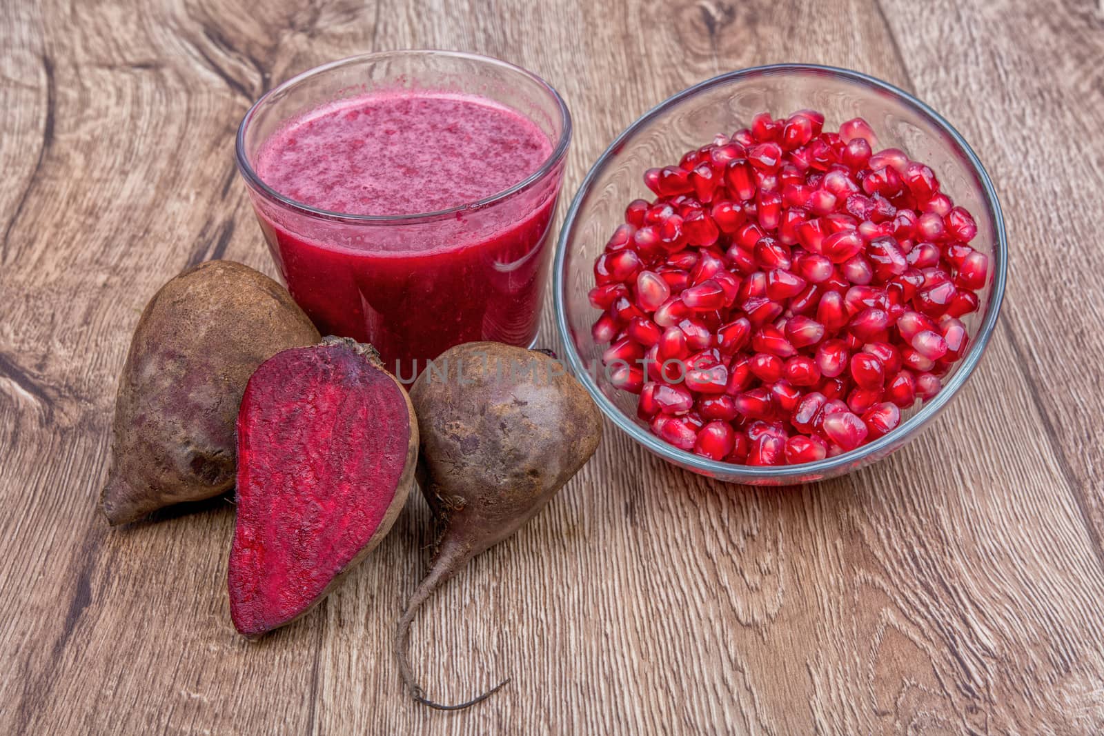 Blended fruit smoothie with ingredients on wooden table
