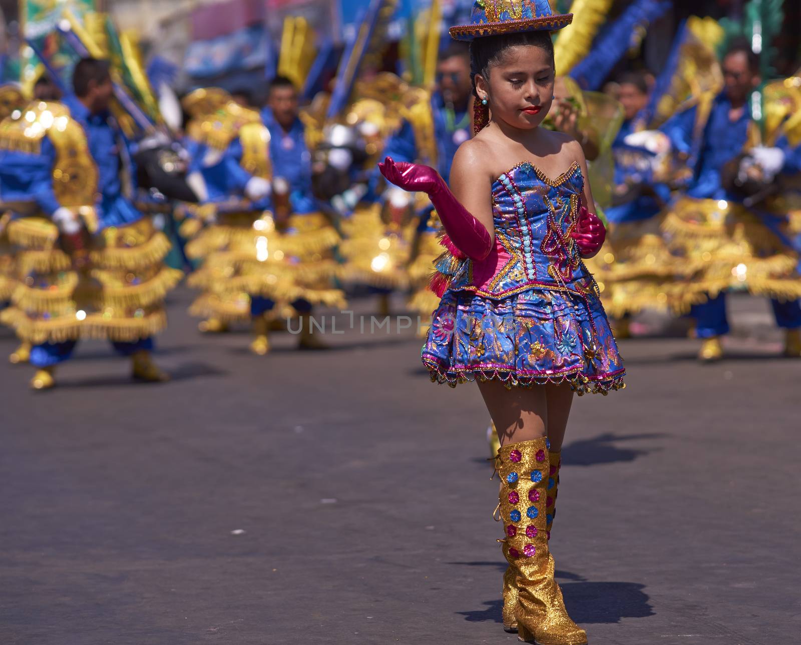 Girl dancer in a Morenada dance group performing a traditional ritual dance as part of the Carnaval Andino con la Fuerza del Sol in Arica, Chile.