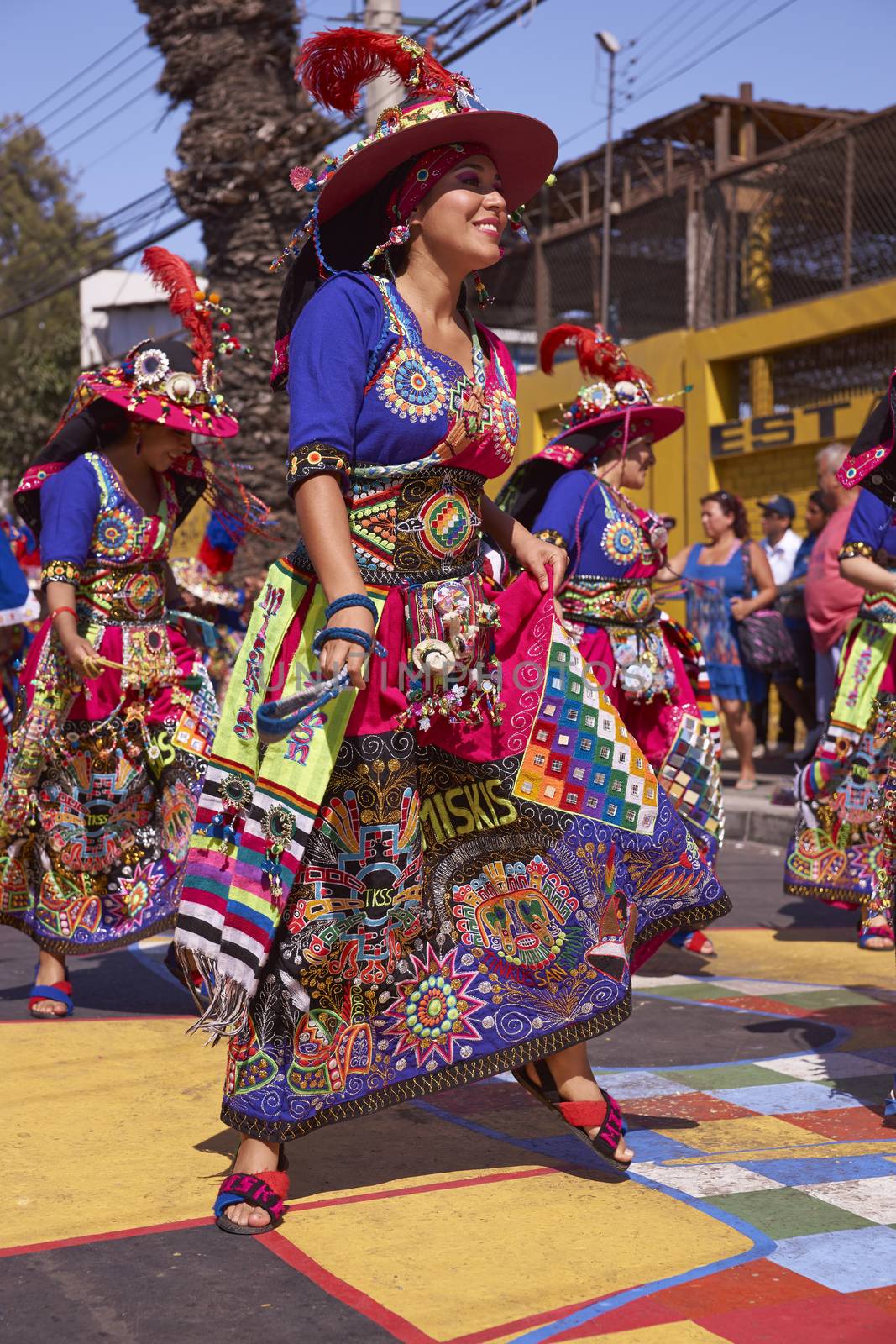 Tinku dancing group in colourful costumes performing a traditional ritual dance as part of the Carnaval Andino con la Fuerza del Sol in Arica, Chile.