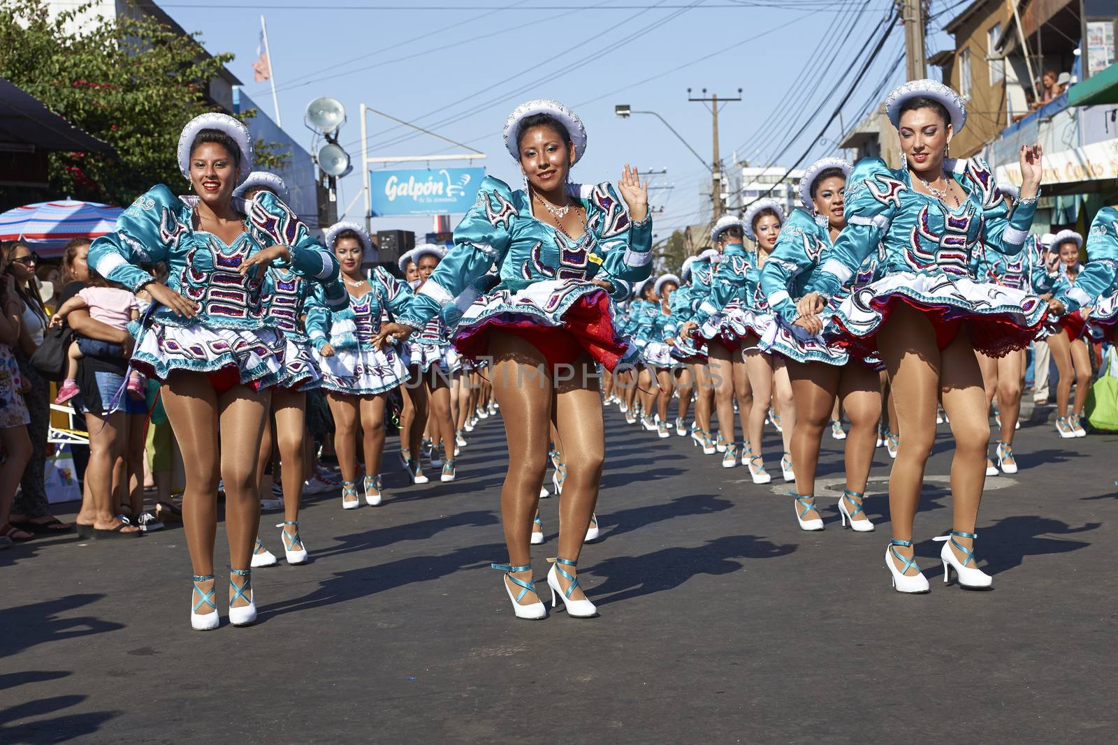 Female members of a Caporales dance group in ornate costumes performing at the annual Carnaval Andino con la Fuerza del Sol in Arica, Chile.