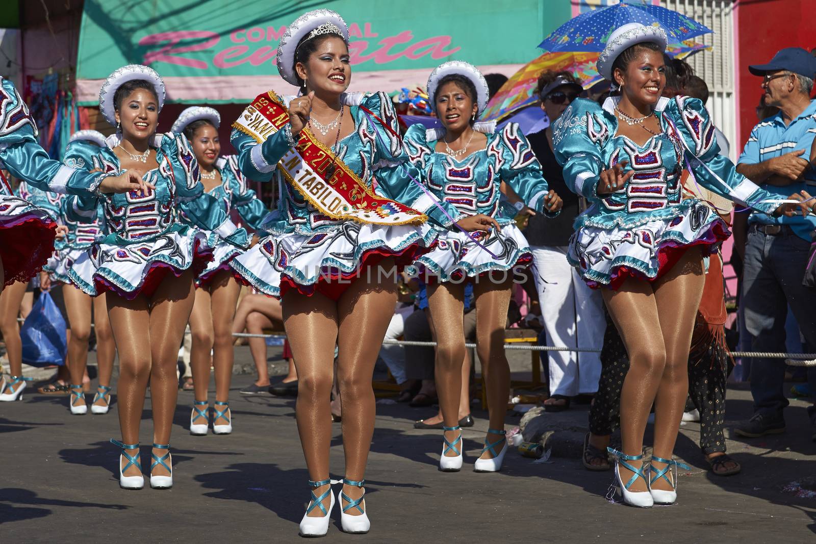 Female members of a Caporales dance group in ornate costumes performing at the annual Carnaval Andino con la Fuerza del Sol in Arica, Chile.