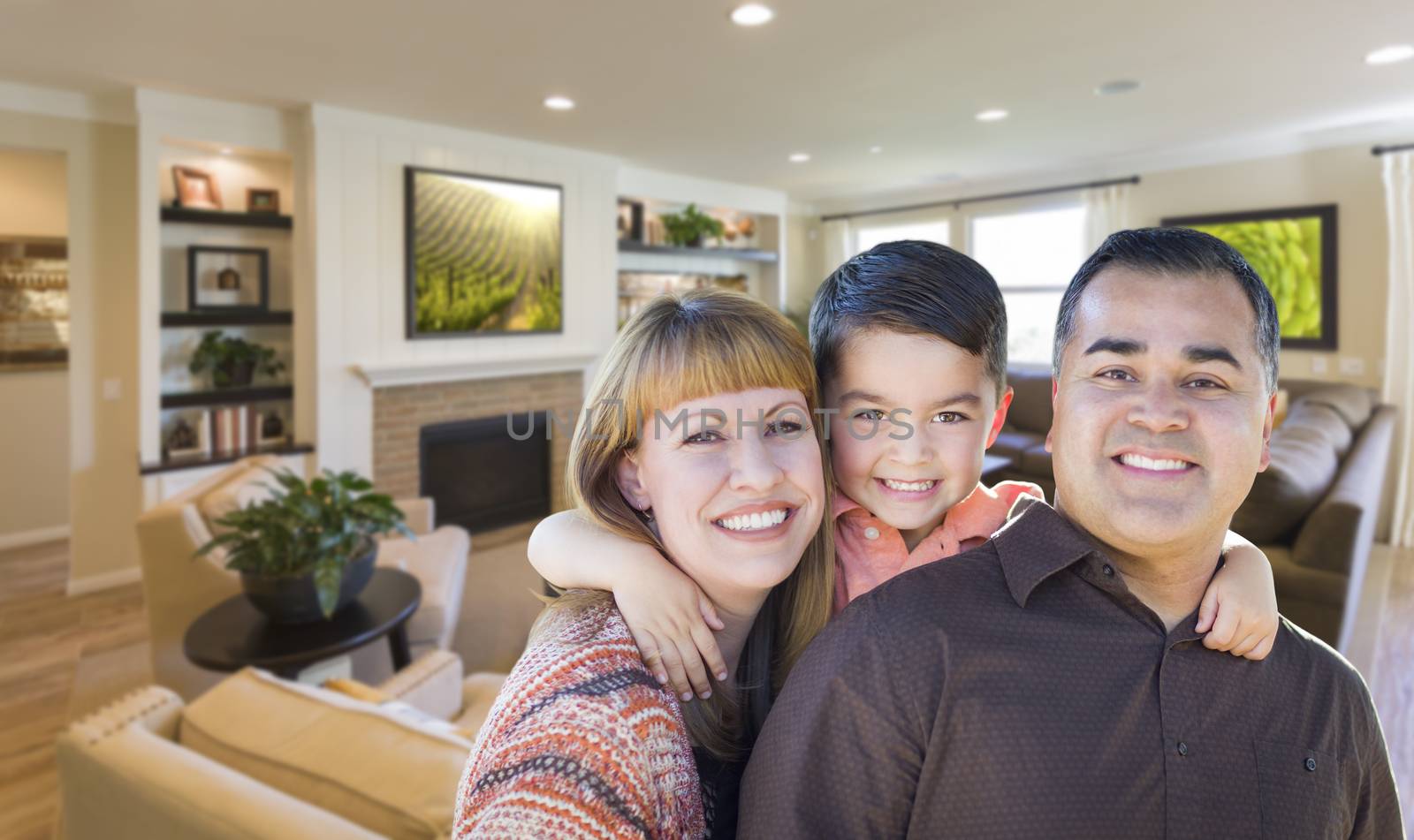 Happy Young Mixed Race Family Portrait In Living Room of Home.